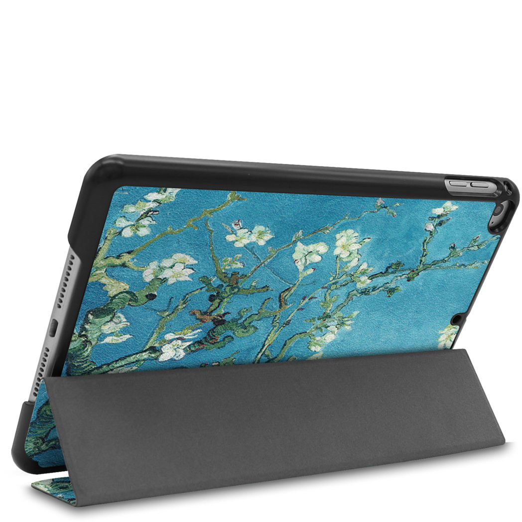 Tablet in a case with a painting on it. The painting is of white flowers on a blue background.