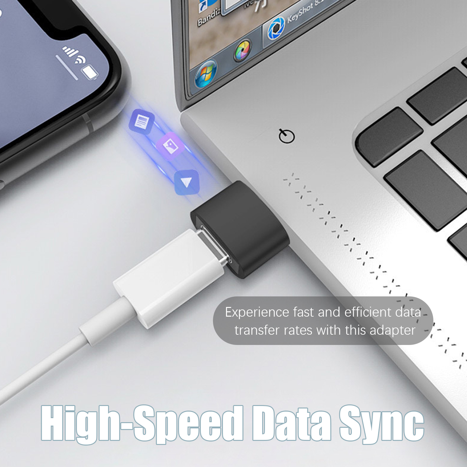 Laptop i adapter z białym kablem podłączonym do telefonu.