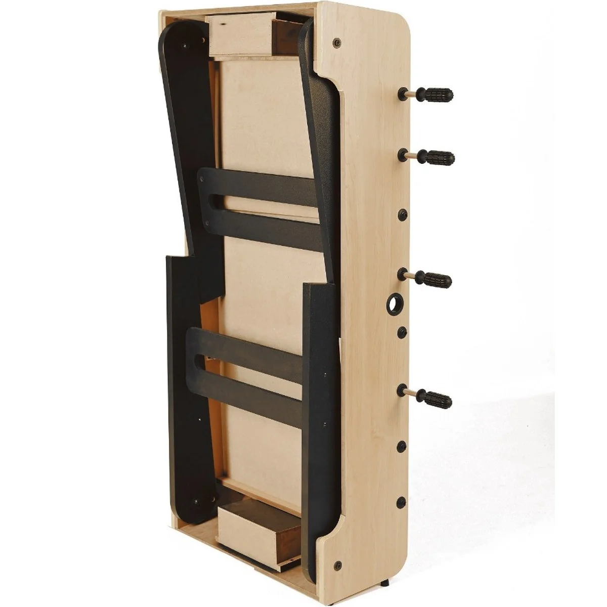 Foosball table standing on its side. Light wood with black details. A small box at the bottom.