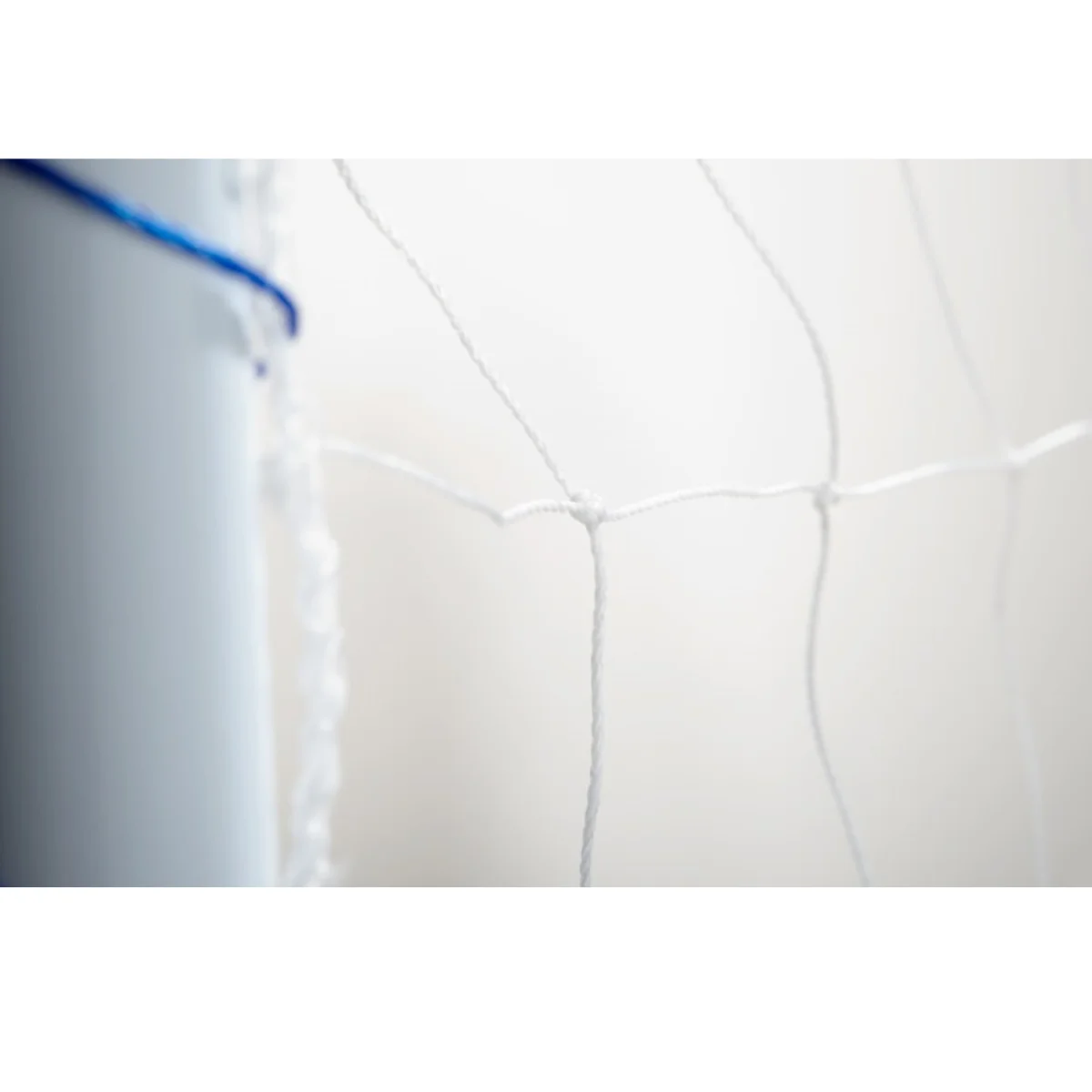 Close-up of a white net. White support post is on the left side. Light background.