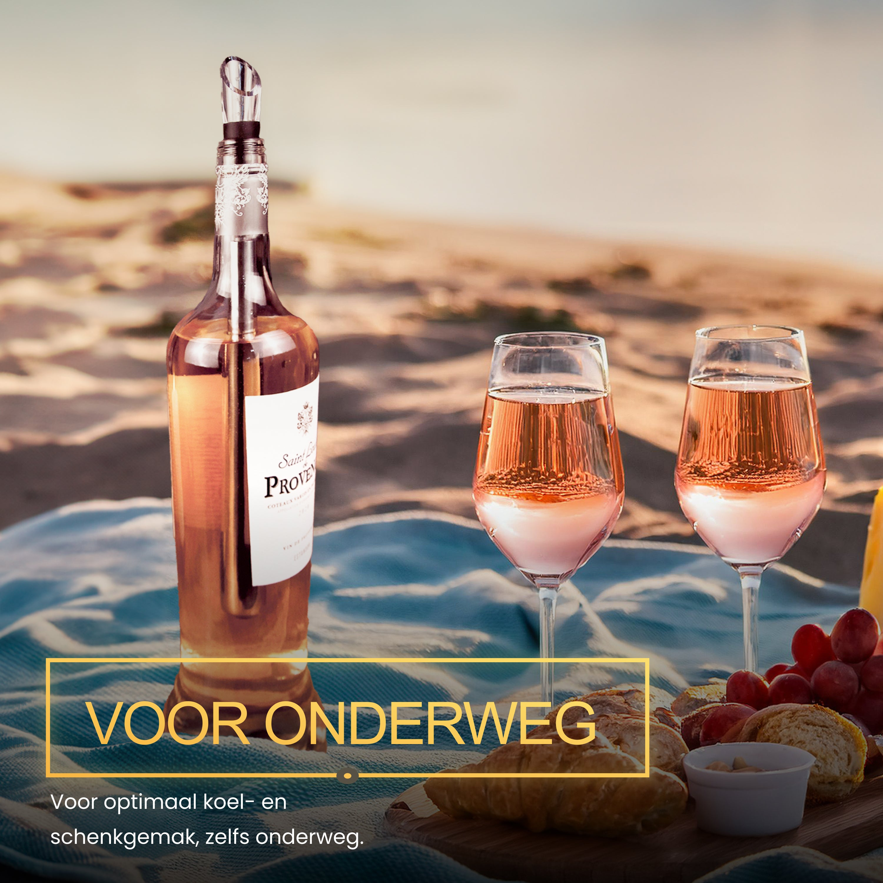 Wine bottle, two glasses with rose wine, food on a beach blanket.