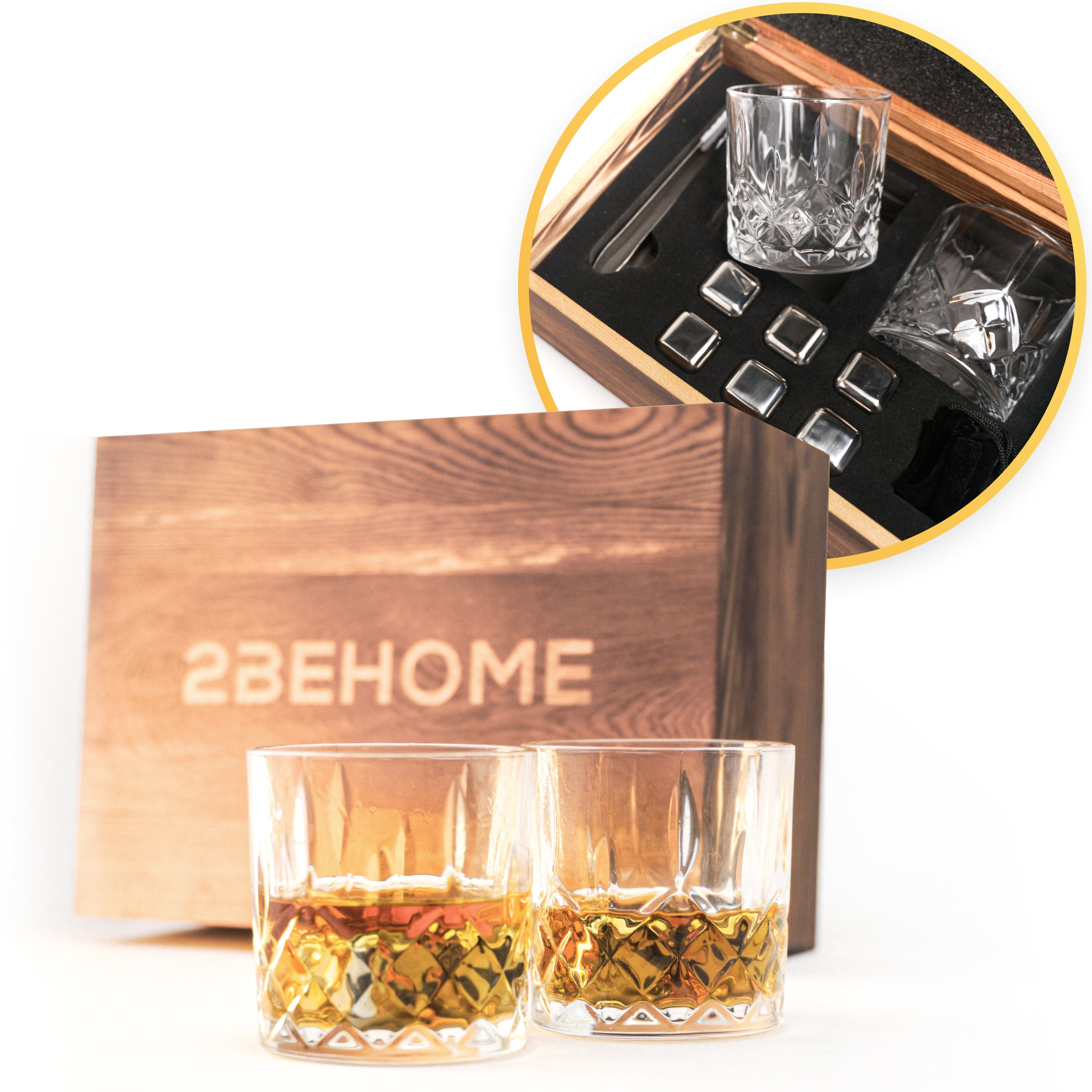 Two whiskey glasses with amber liquid, a wooden box, and ice cubes in a wooden box.