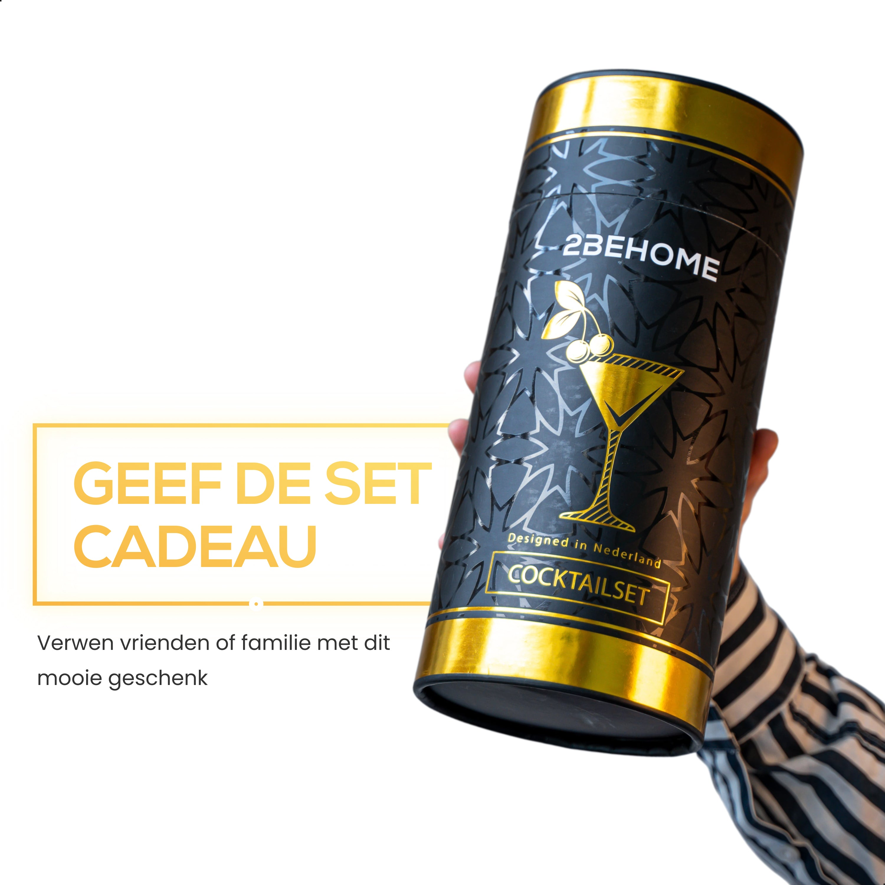 Black and gold cocktail set gift box held by a person. The box has a cocktail glass design.