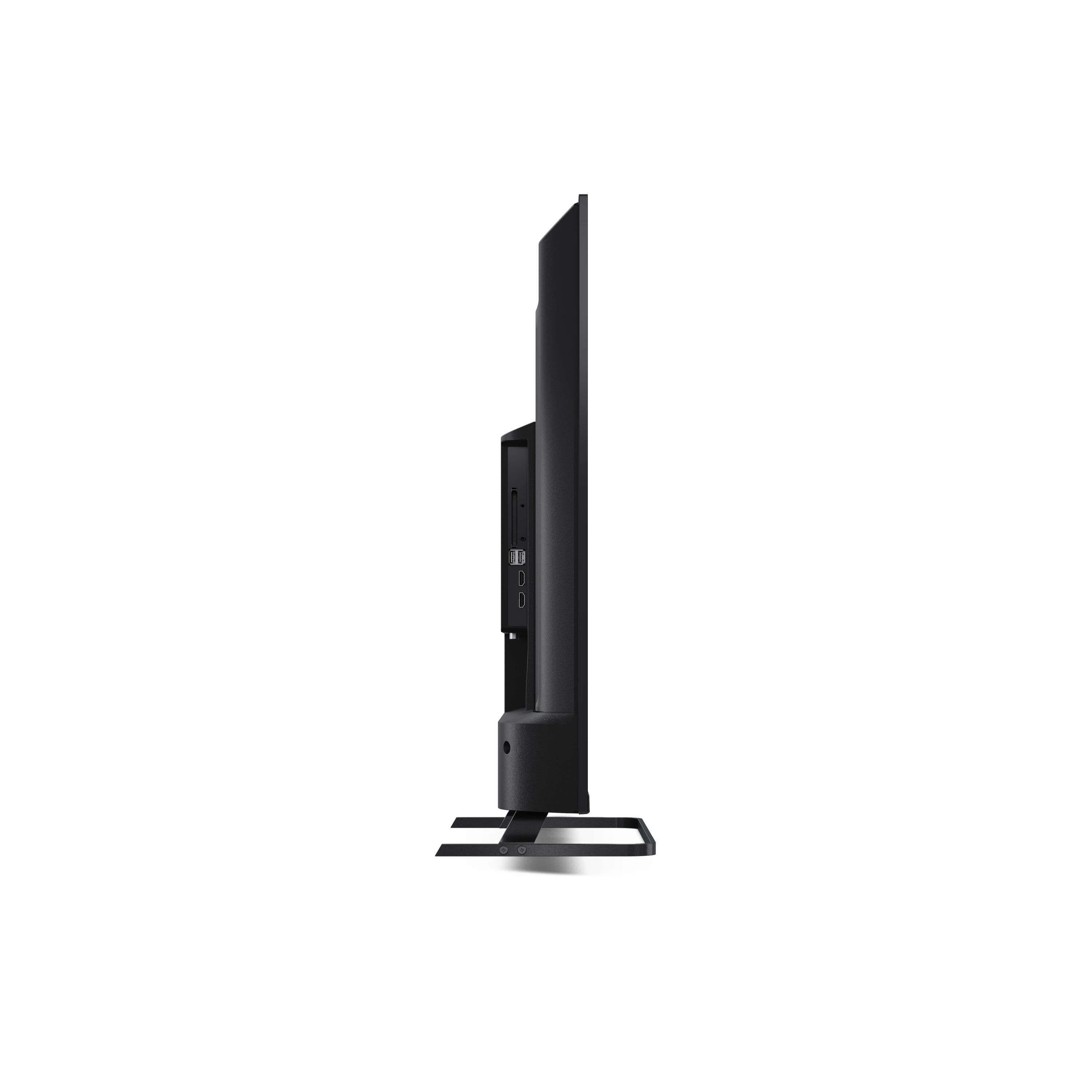 Vue latérale d'une télévision noire. Elle est posée sur un socle.