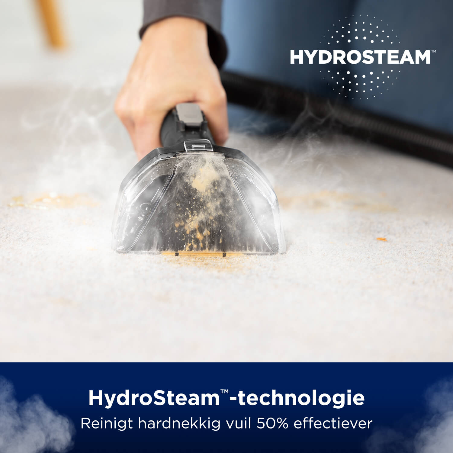 Person cleaning carpet with a HydroSteam device. White carpet with steam.