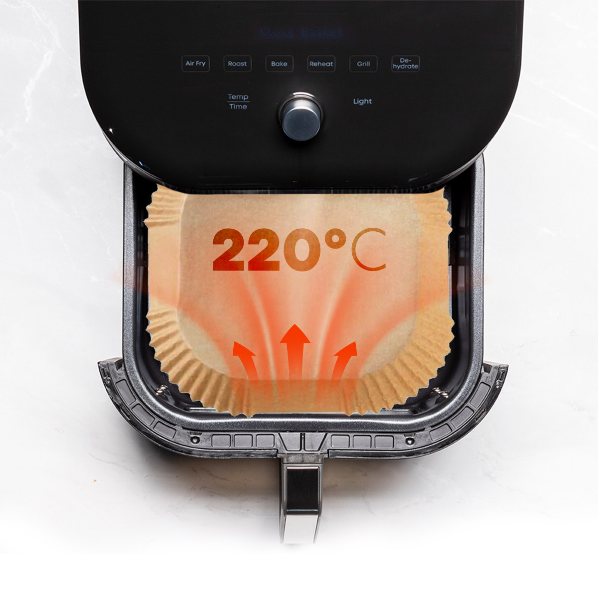 Air fryer showing the paper tray inside with the temperature set to 220°C. The arrows indicate heat.