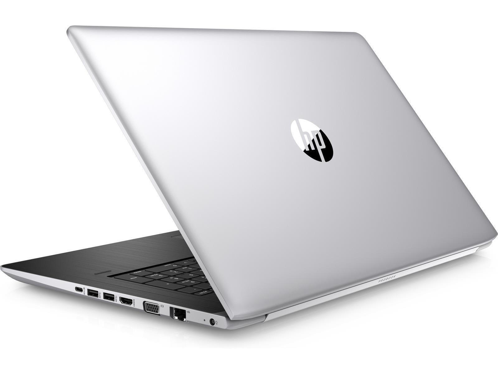 Ein silberner Laptop mit schwarzer Tastatur, geöffnet auf einer weißen Oberfläche.