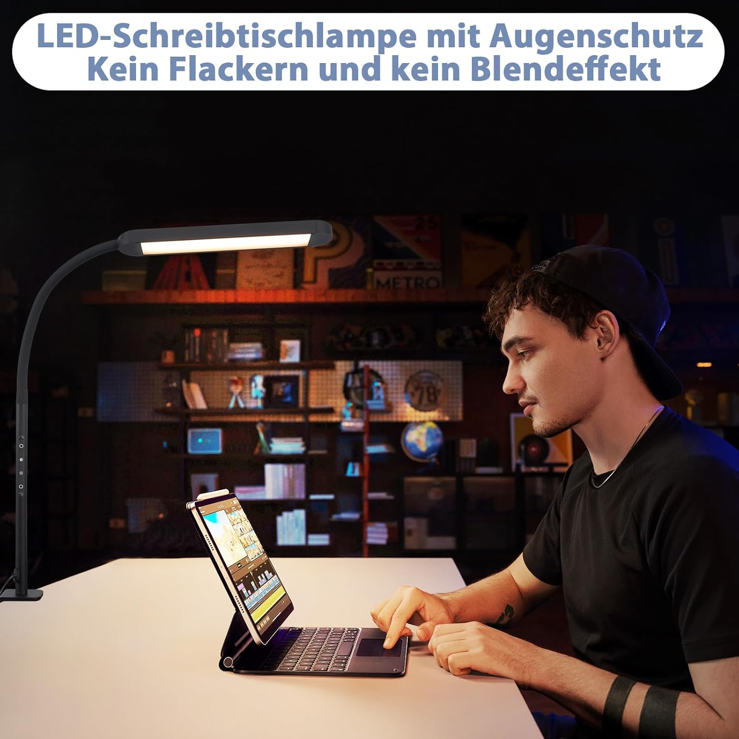 Mężczyzna używający tabletu z klawiaturą pod czarną lampą biurkową, w pokoju.