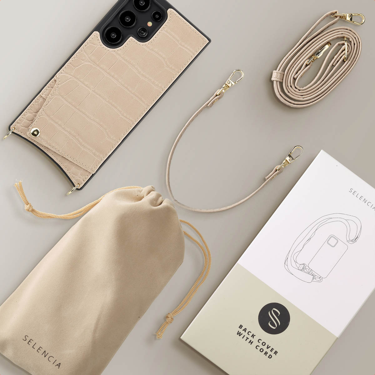 Coque de téléphone avec cordon, téléphone et accessoires. Couleur beige et une boîte de marque avec contour de téléphone.