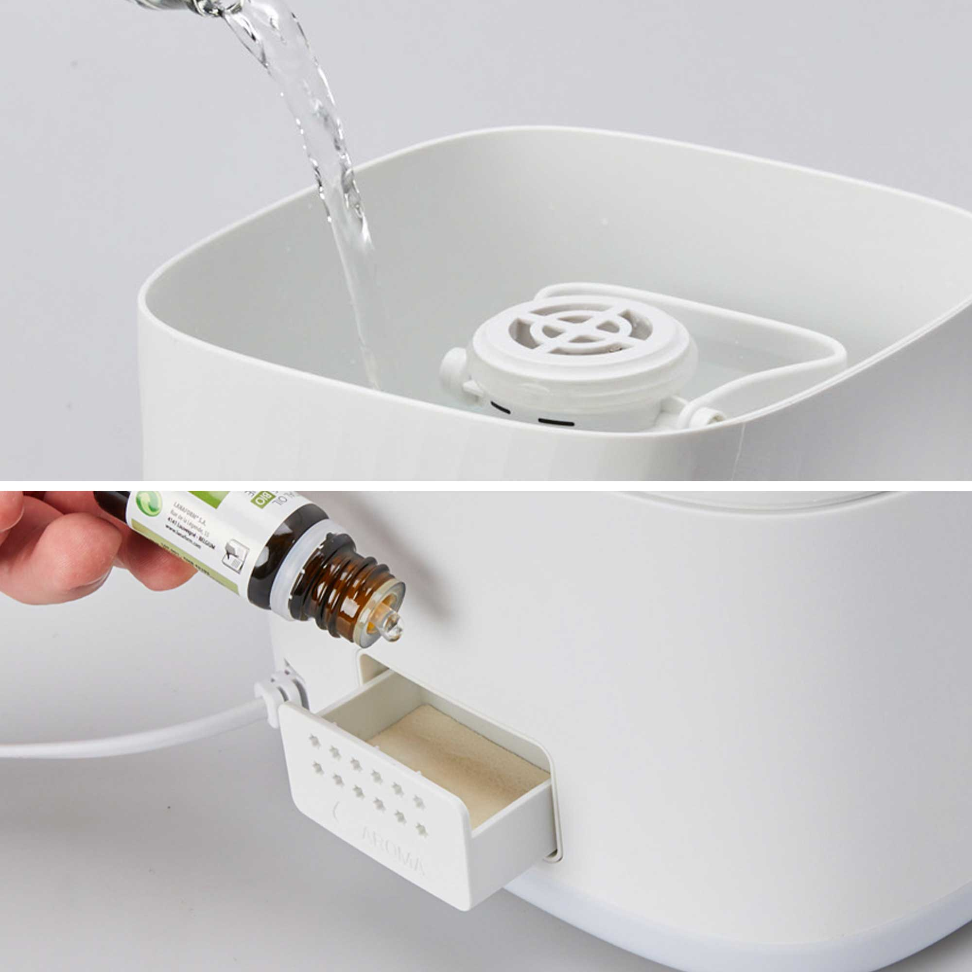 A white humidifier with water being poured in and essential oil being added.