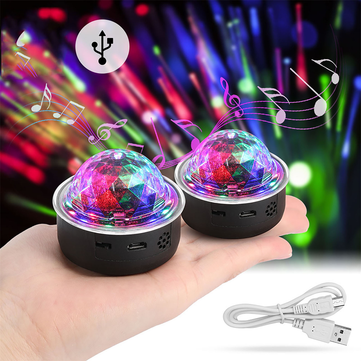 Zwei Discokugeln auf einer Hand, mit einem USB-Kabel und Noten. Die Lichter sind farbenfroh.