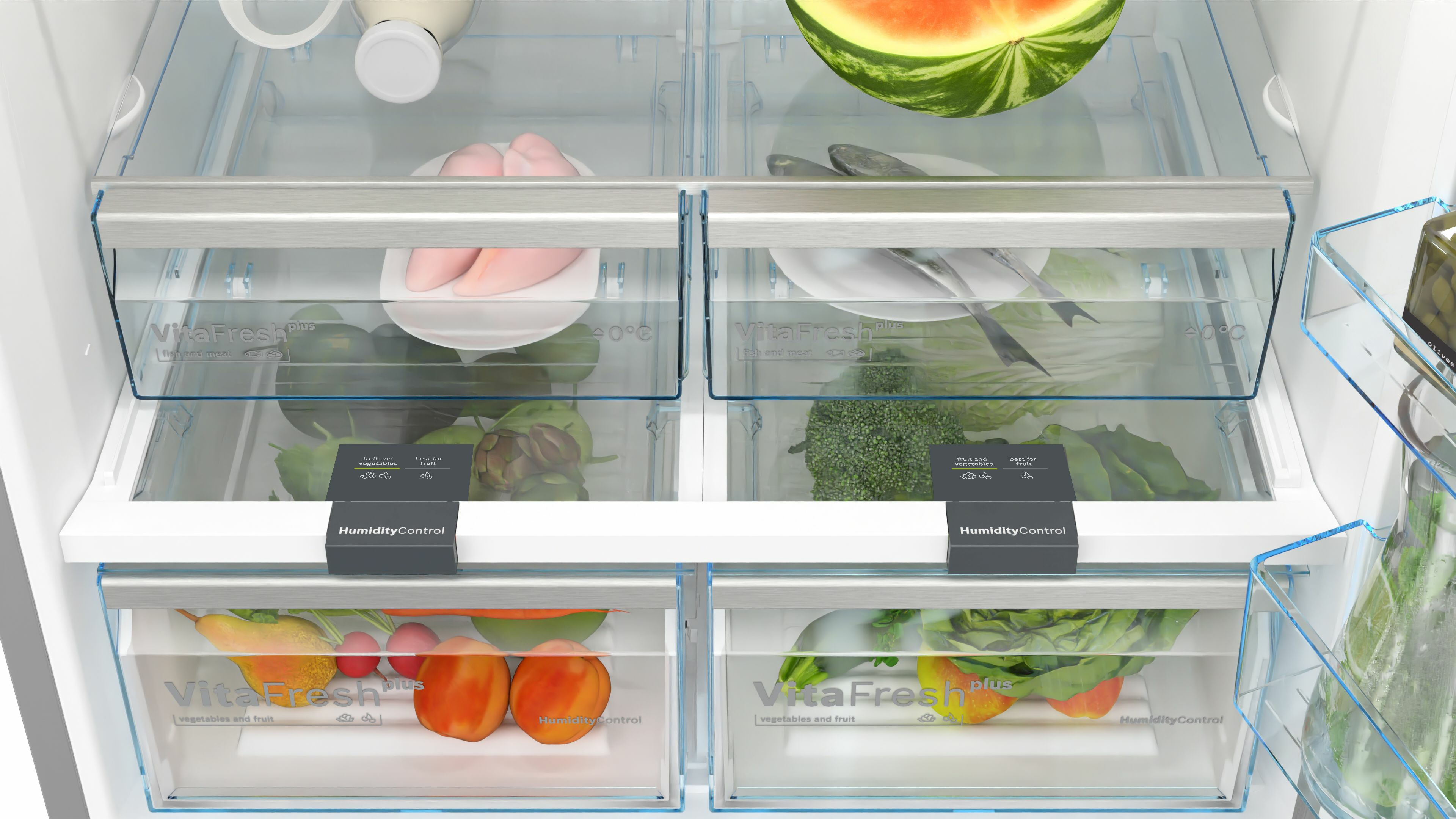 Nahaufnahme der Schubladen eines Kühlschranks. Obst, Gemüse und Fleisch sind gelagert. Der Hintergrund ist weiß.