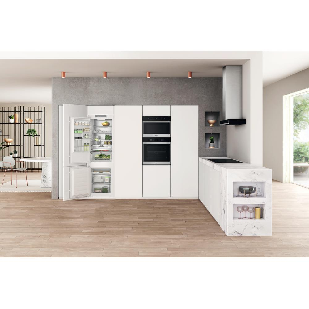Kitchen with built-in appliances, refrigerator open.