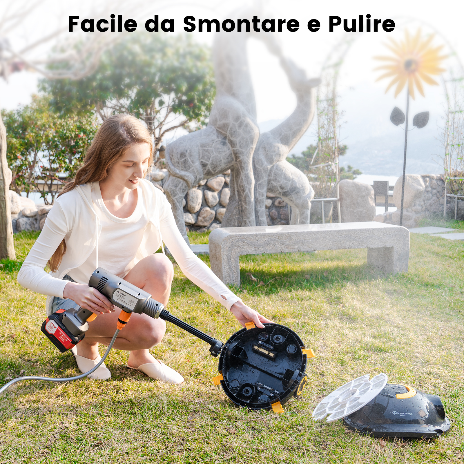 Una donna pulisce un dispositivo nero e giallo con acqua in un giardino. Il dispositivo è smontato per la pulizia.