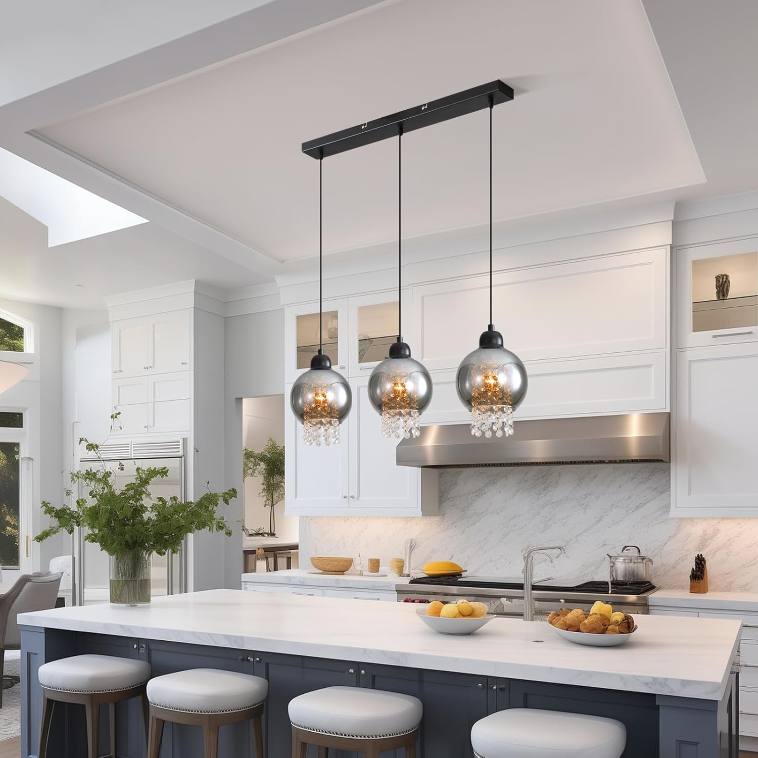 Cocina con luces colgantes de globo, isla con taburetes y gabinetes blancos.