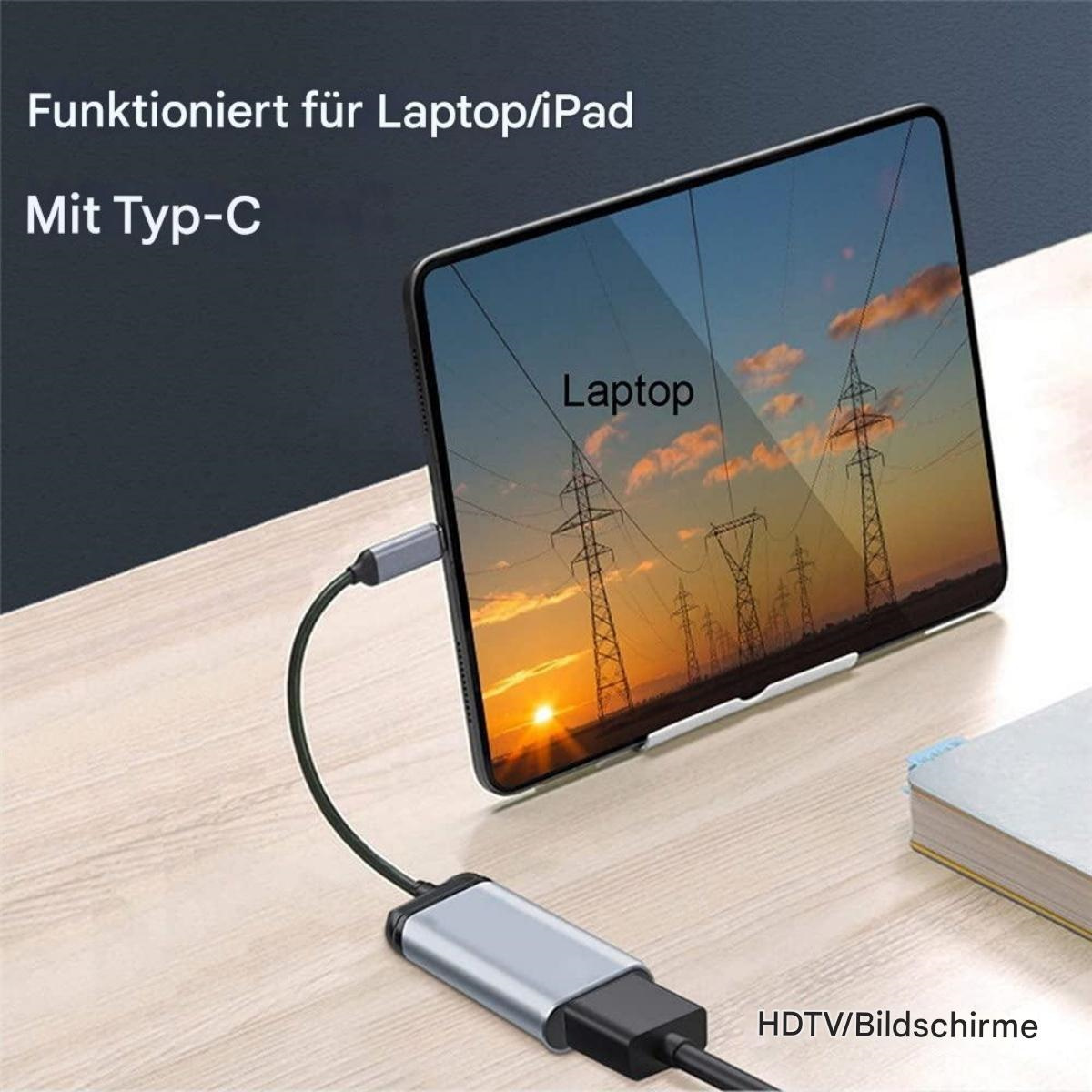 Ein Tablet, das eine Sonnenuntergangsszene anzeigt, verbunden mit einem silbernen Adapter mit schwarzem Kabel.