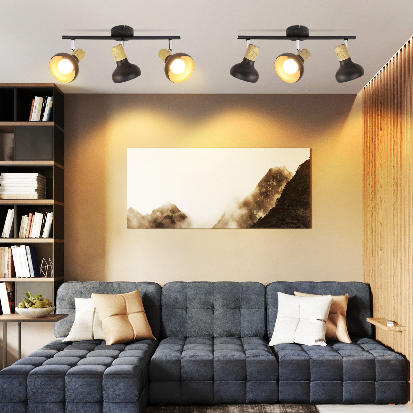 Nowoczesny salon z szarą sofą, dziełami sztuki i oświetleniem sufitowym oświetlającym przestrzeń.