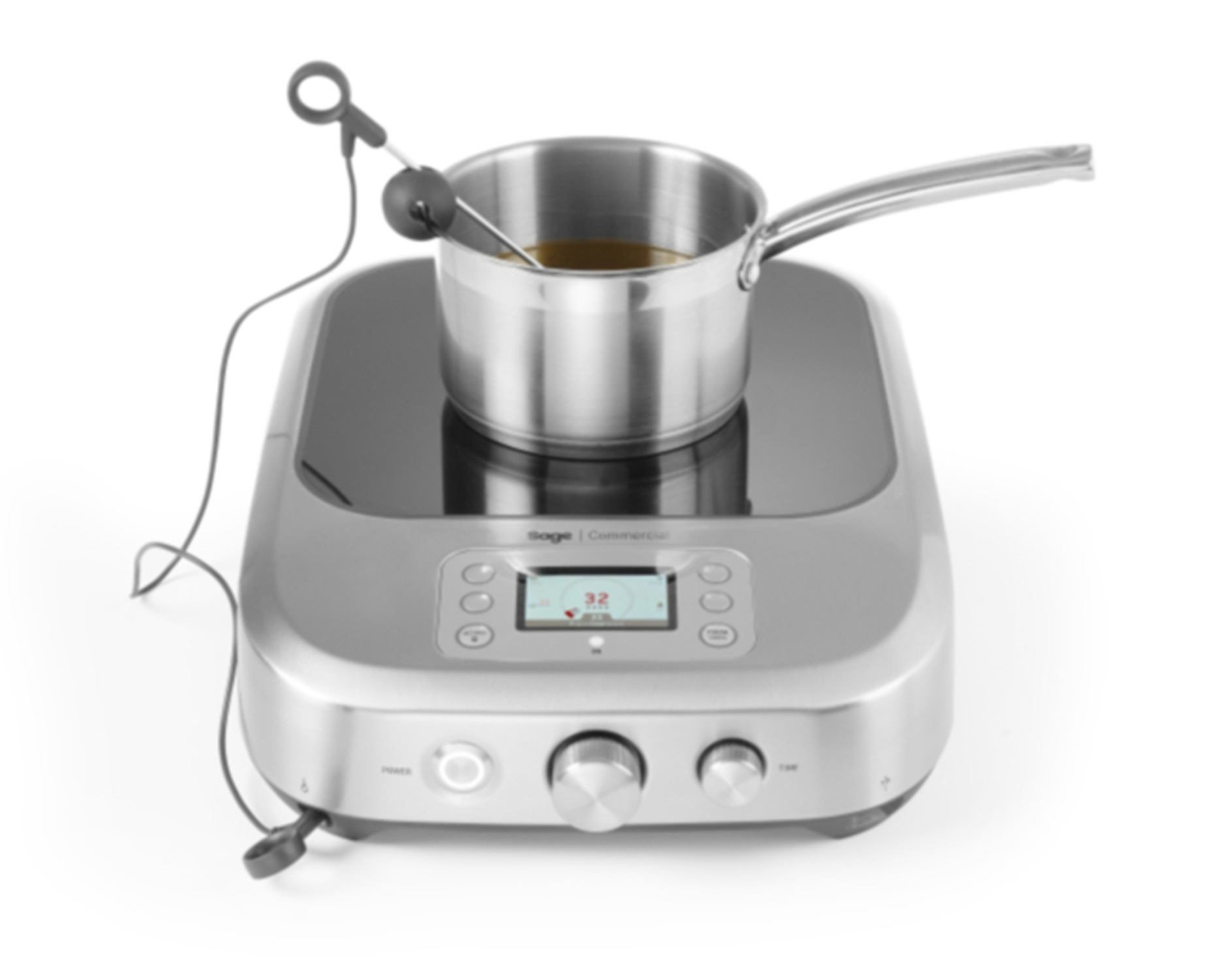 A silver induction cooktop with a pan, a thermometer, and a digital display showing the temperature.