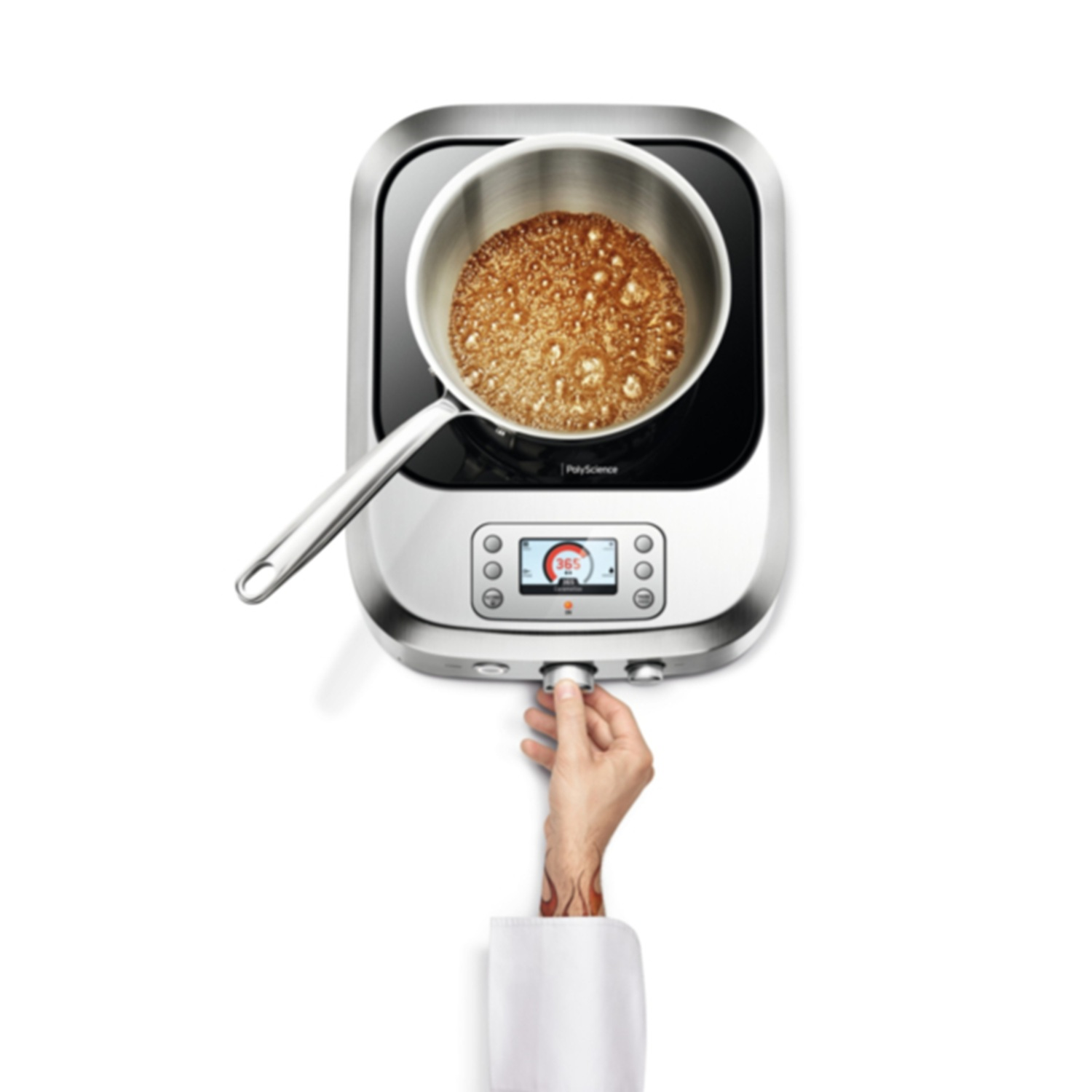 A hand adjusts a knob on an induction cooktop with a pot of bubbling liquid.
