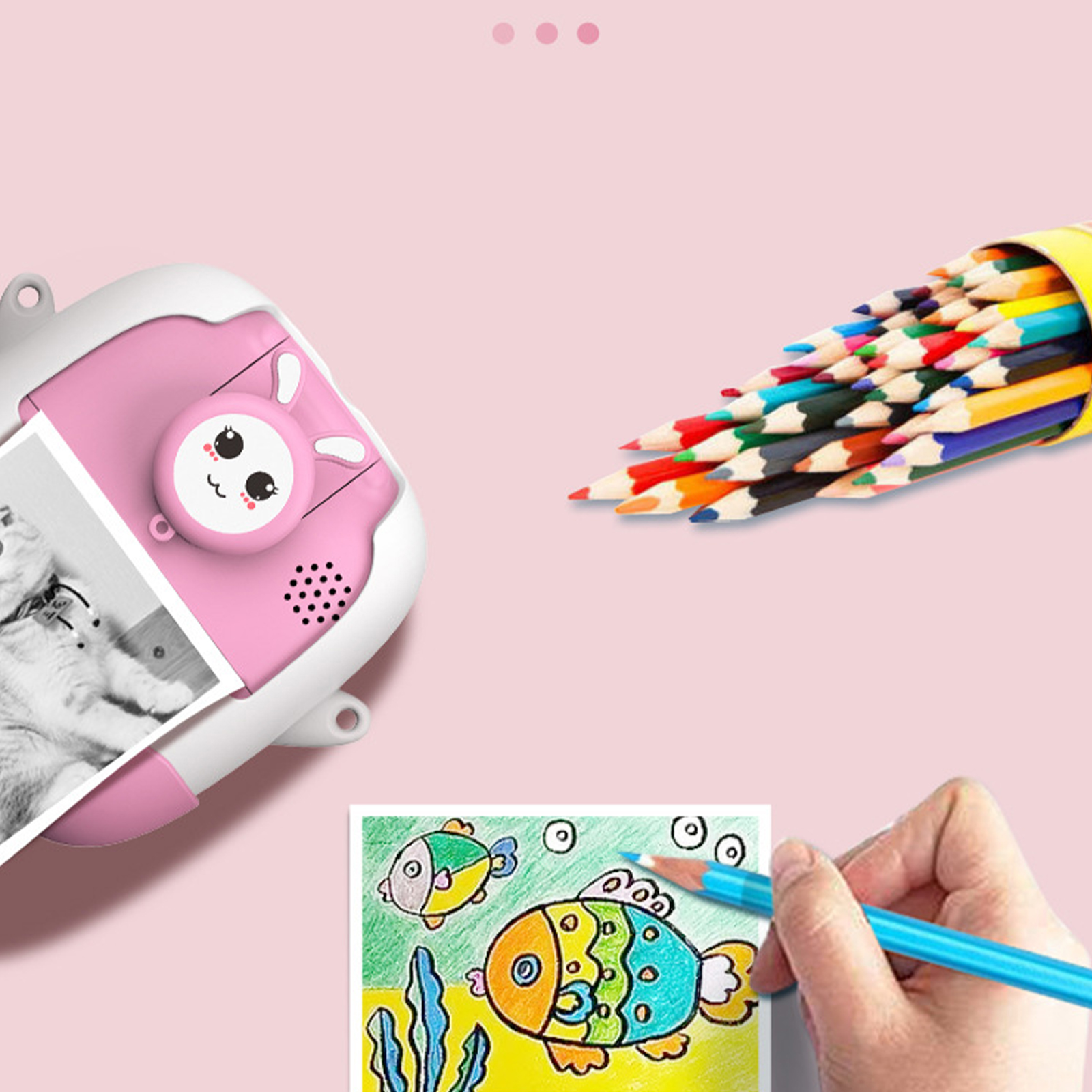 Eine rosa Kamera mit einem Bild und Buntstiften, die einen Fisch zeichnen. Die Szene ist farbenfroh.
