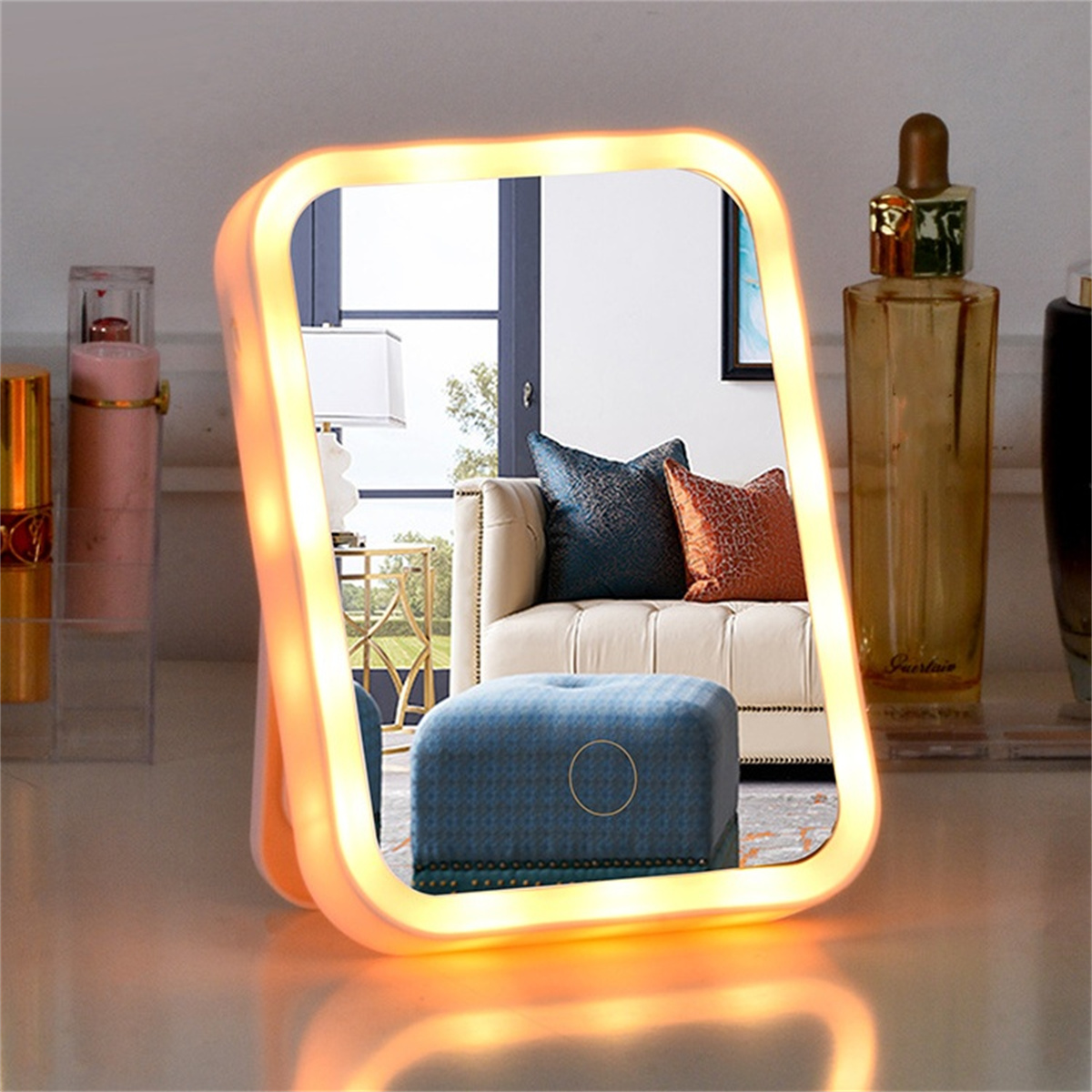 Ein beleuchteter quadratischer Spiegel, der einen Raum mit Sofa und Dekor reflektiert.