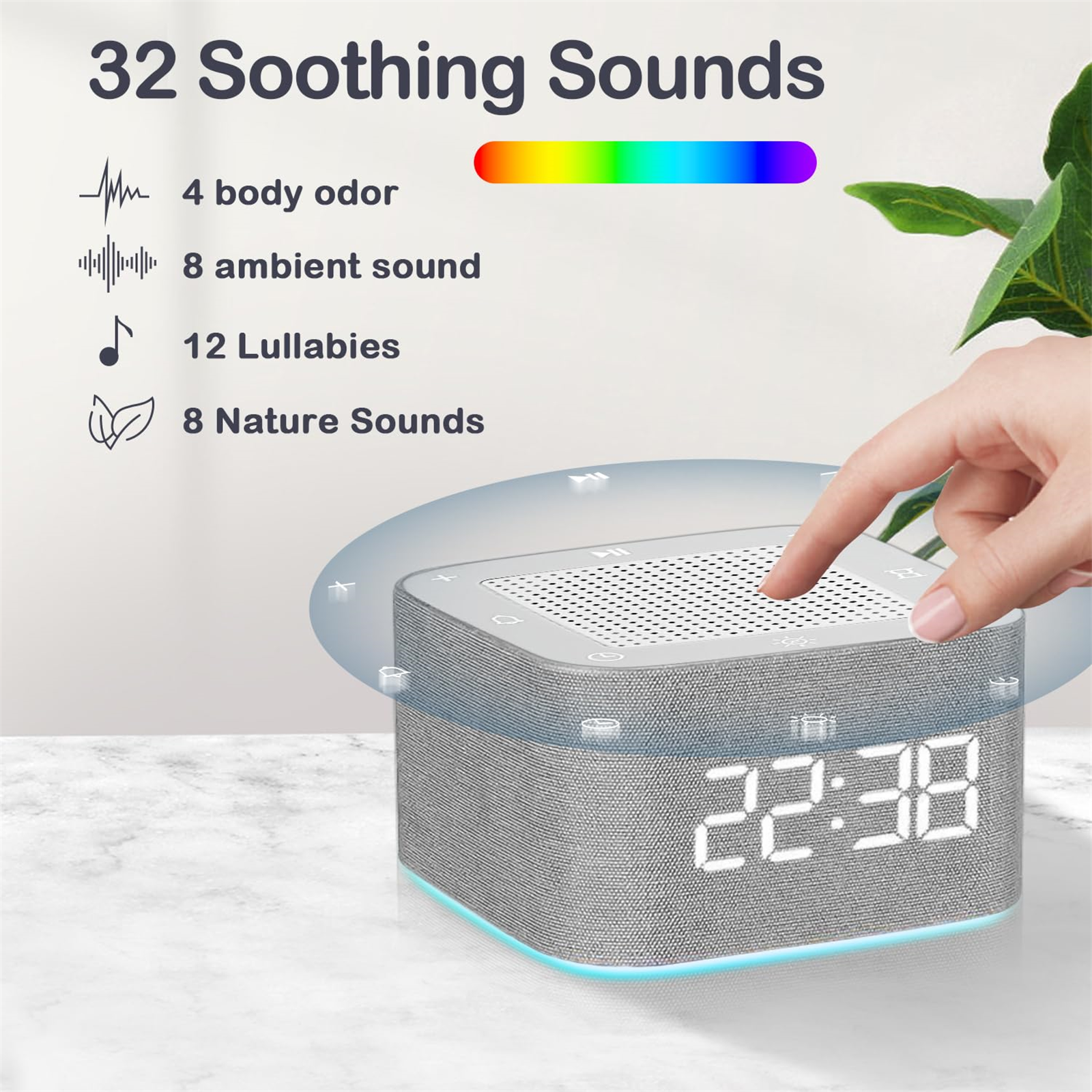 Graue Soundmaschine mit digitaler Anzeige und Hand, die die Oberseite berührt.