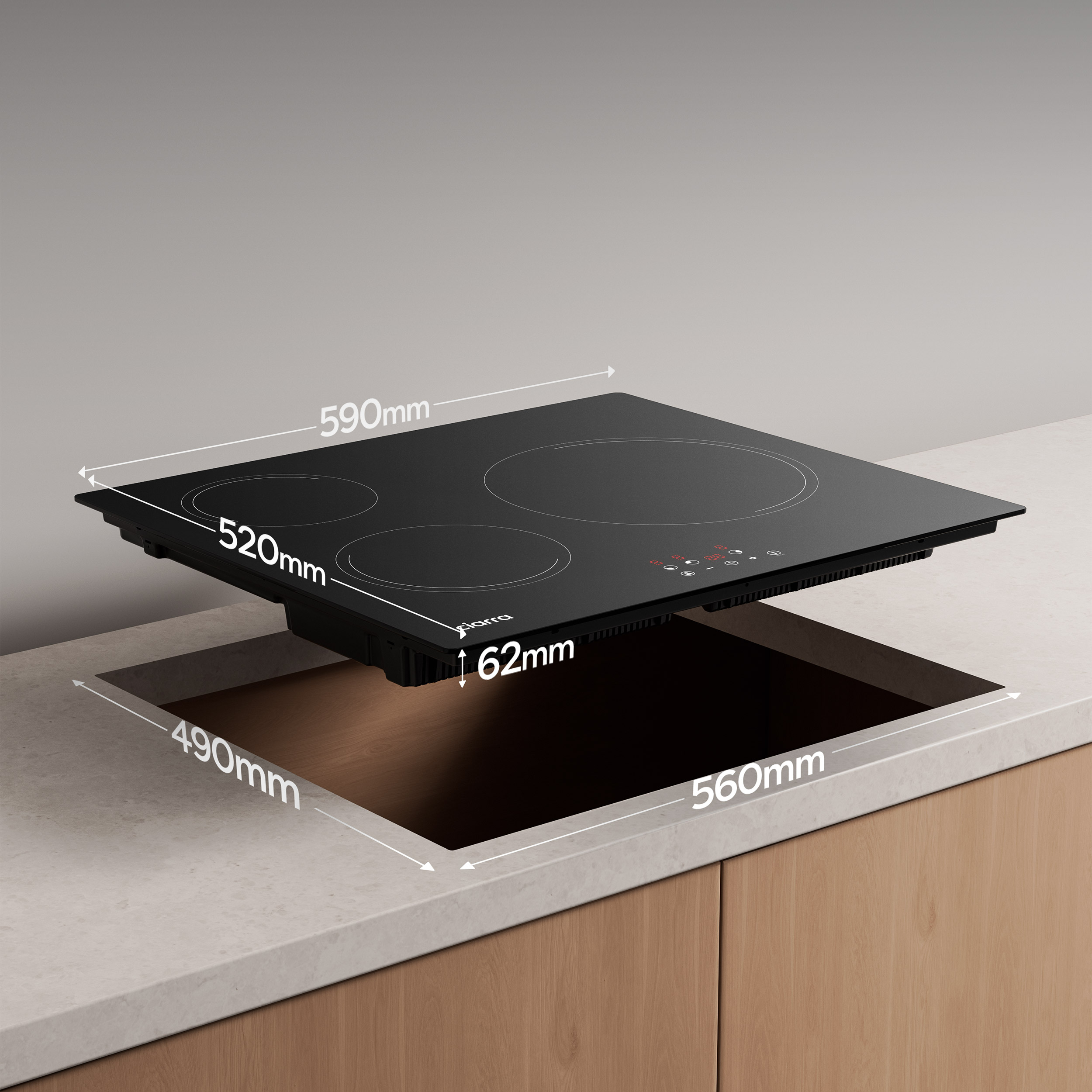 Piano cottura a induzione nero con quattro fuochi, su un piano di lavoro bianco.