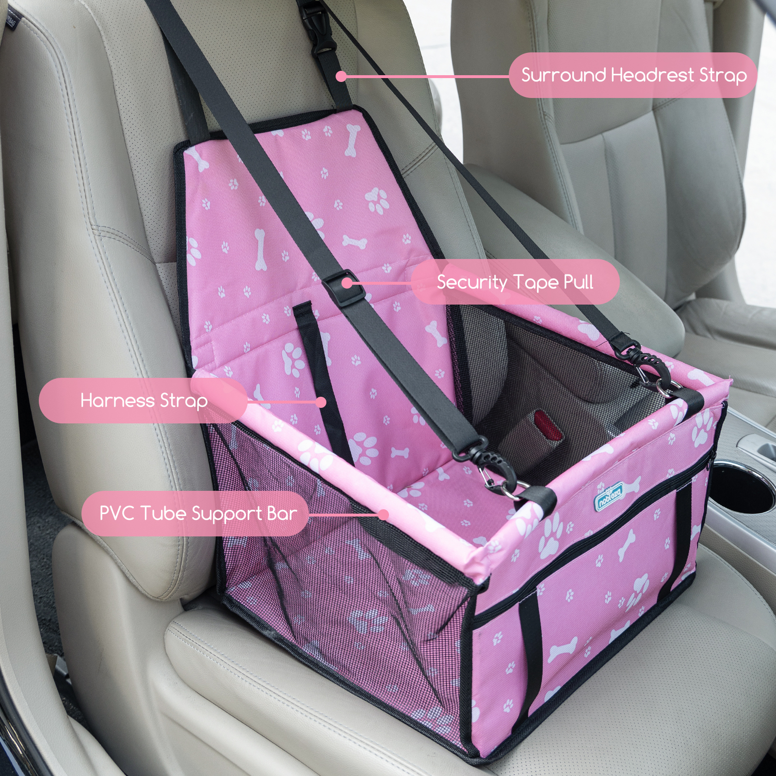 Asiento de coche rosa para mascotas con correas negras, diseño de huellas y características de seguridad.