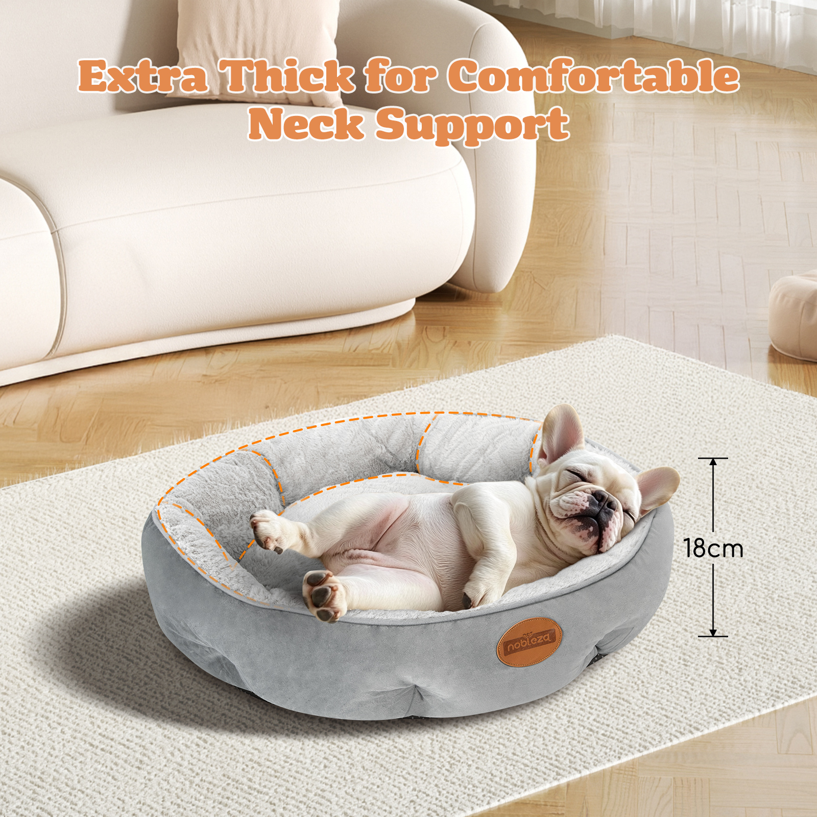 Cama para perros con bulldog francés durmiendo. La cama es gris.