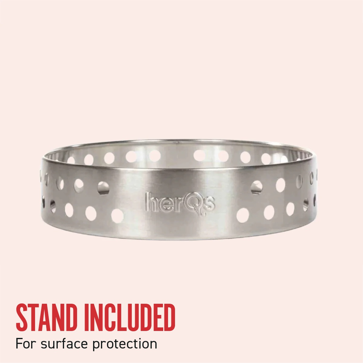 A silver metal fire pit ring with holes and the brand name. Pink background.