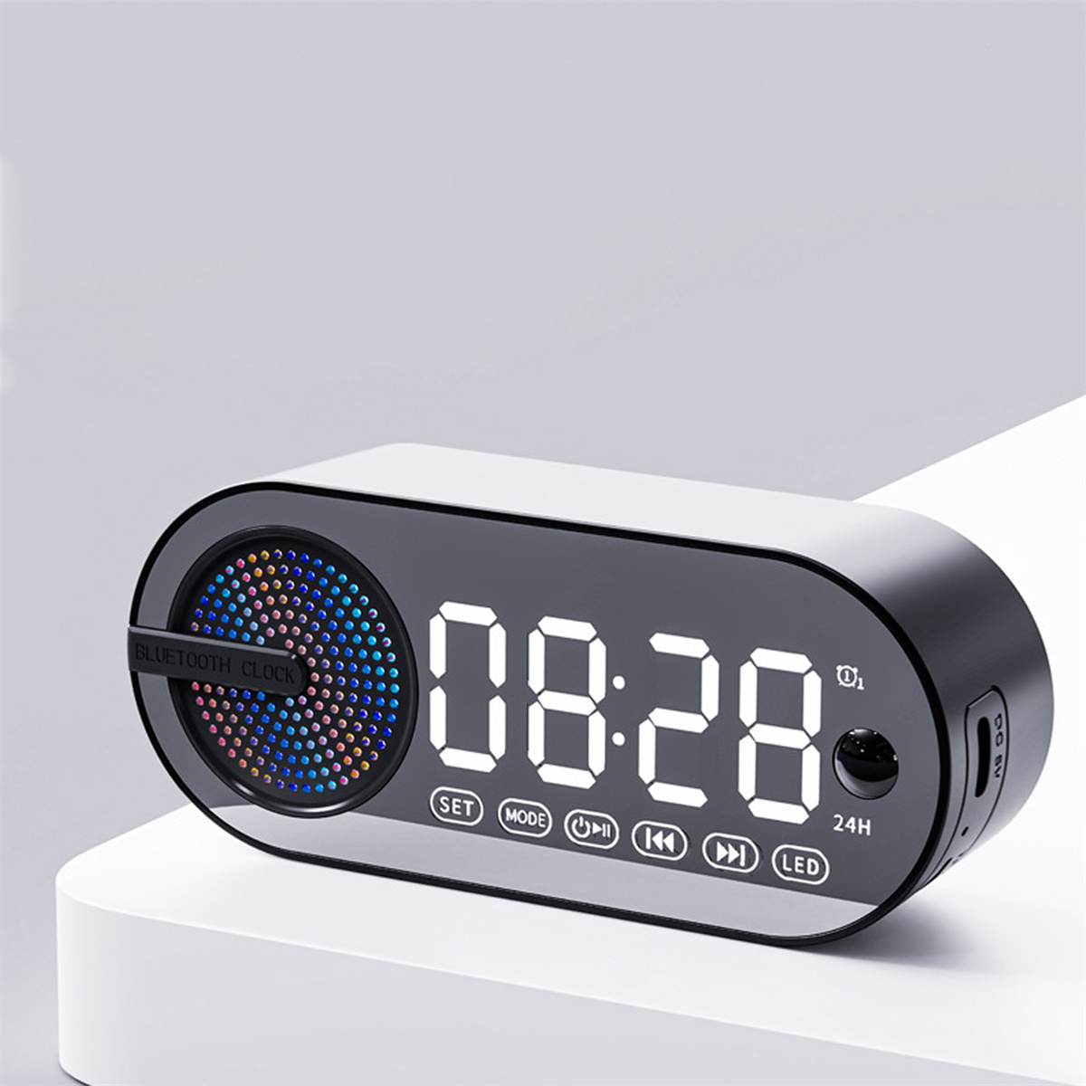 Schwarze Digitaluhr mit beleuchtetem Display. Zeigt 08:28 an. Hat Knöpfe für Set, Mode und LED.