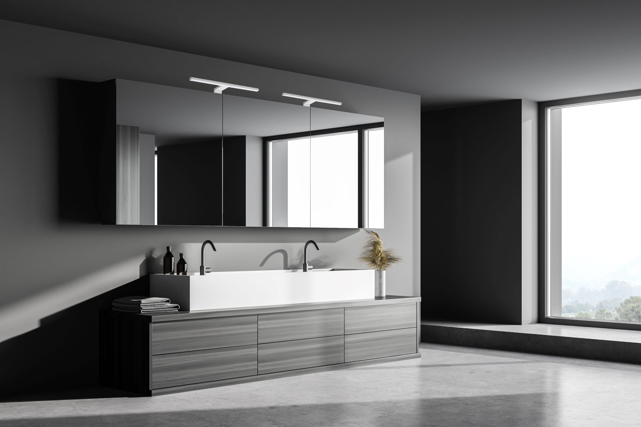 Modernes Badezimmer mit großem Spiegel über einem Doppelwaschbecken. Dunkelgraue Wände.