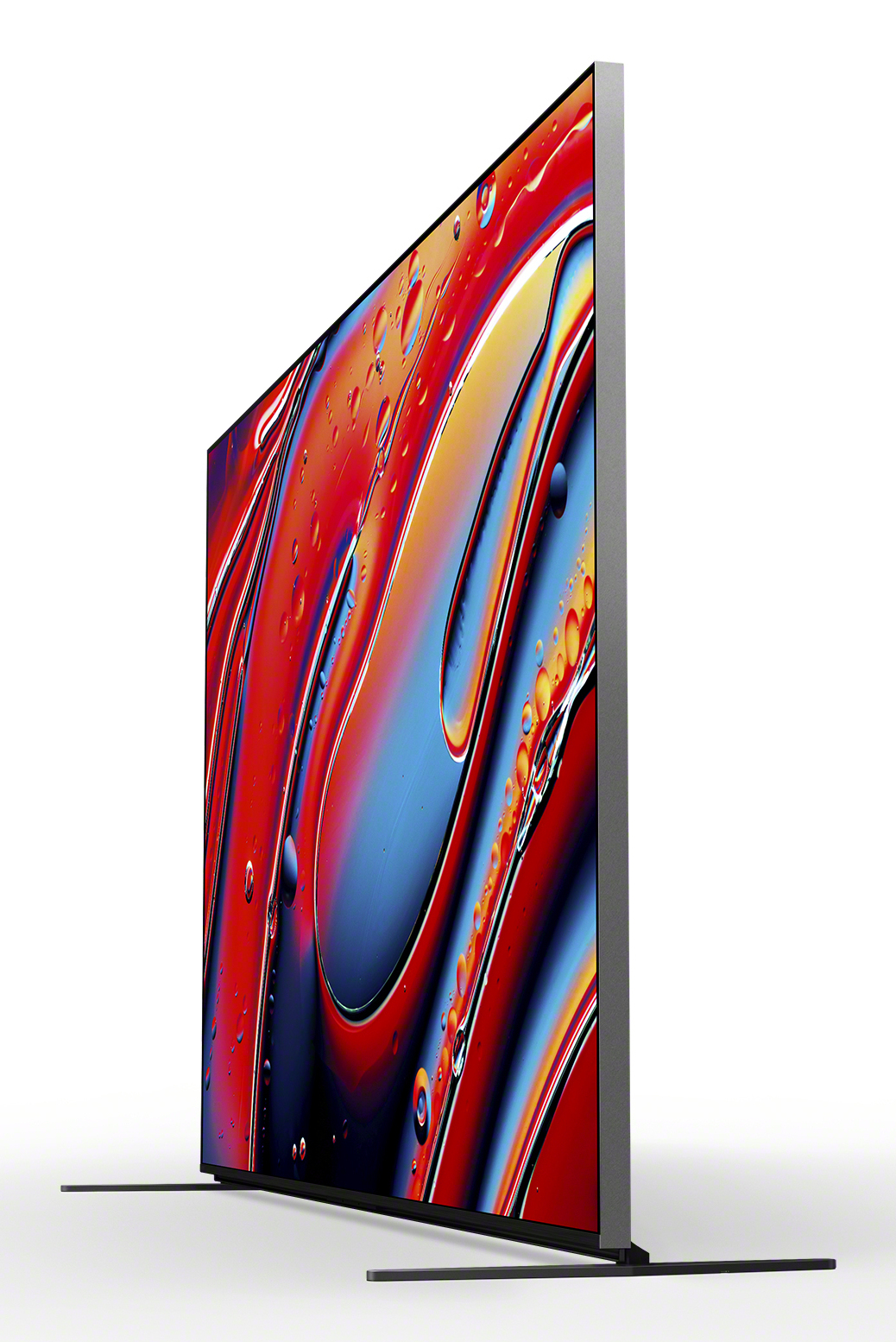 Une télévision élégante affiche un art abstrait coloré. Son cadre argenté repose sur une surface blanche.