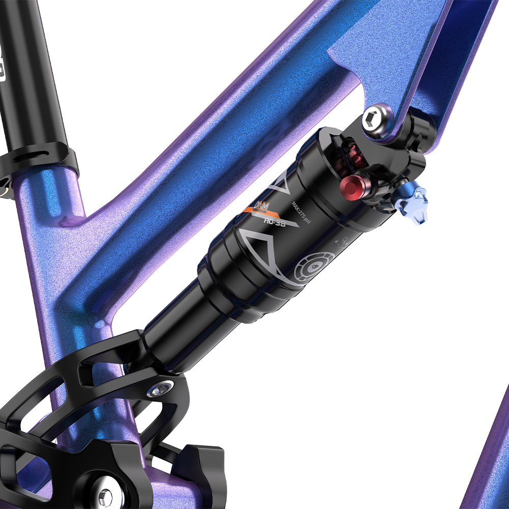 Primer plano de un amortiguador de bicicleta con un marco azul y morado metálico, con etiquetas y diales.