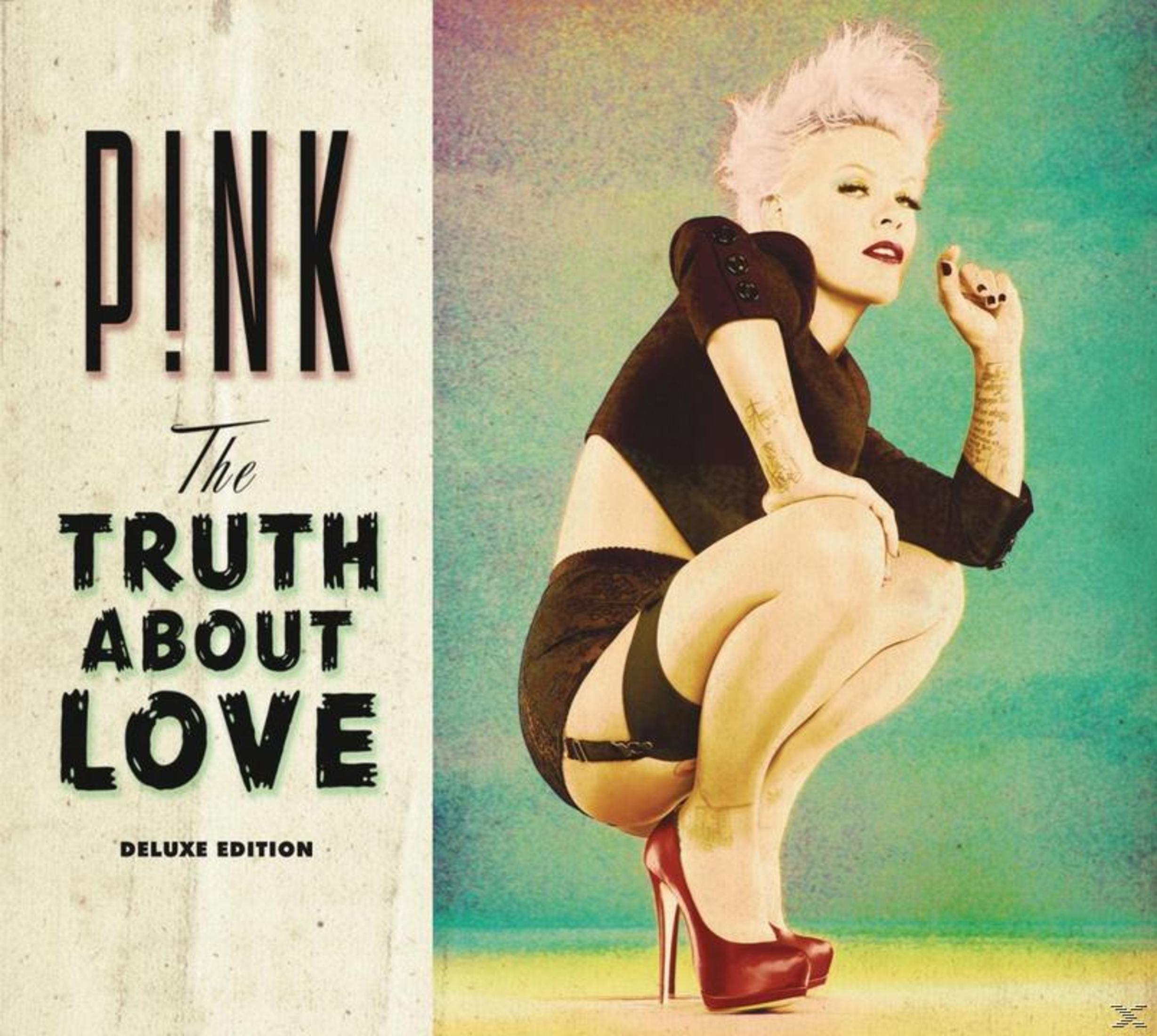 Copertina dell'album, P!nk, una donna in abito nero, in ginocchio, scarpe rosse e testo.