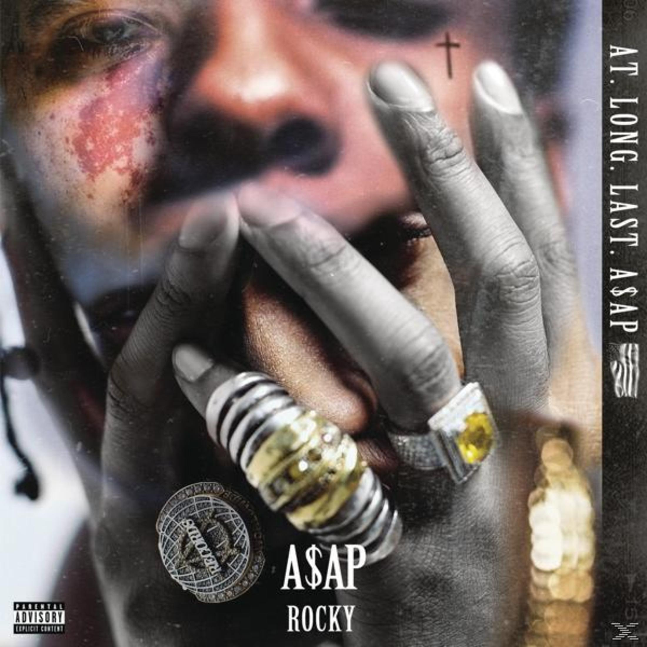 Copertina dell'album di A$AP Rocky. Primo piano di un uomo con anelli e un tatuaggio a croce.