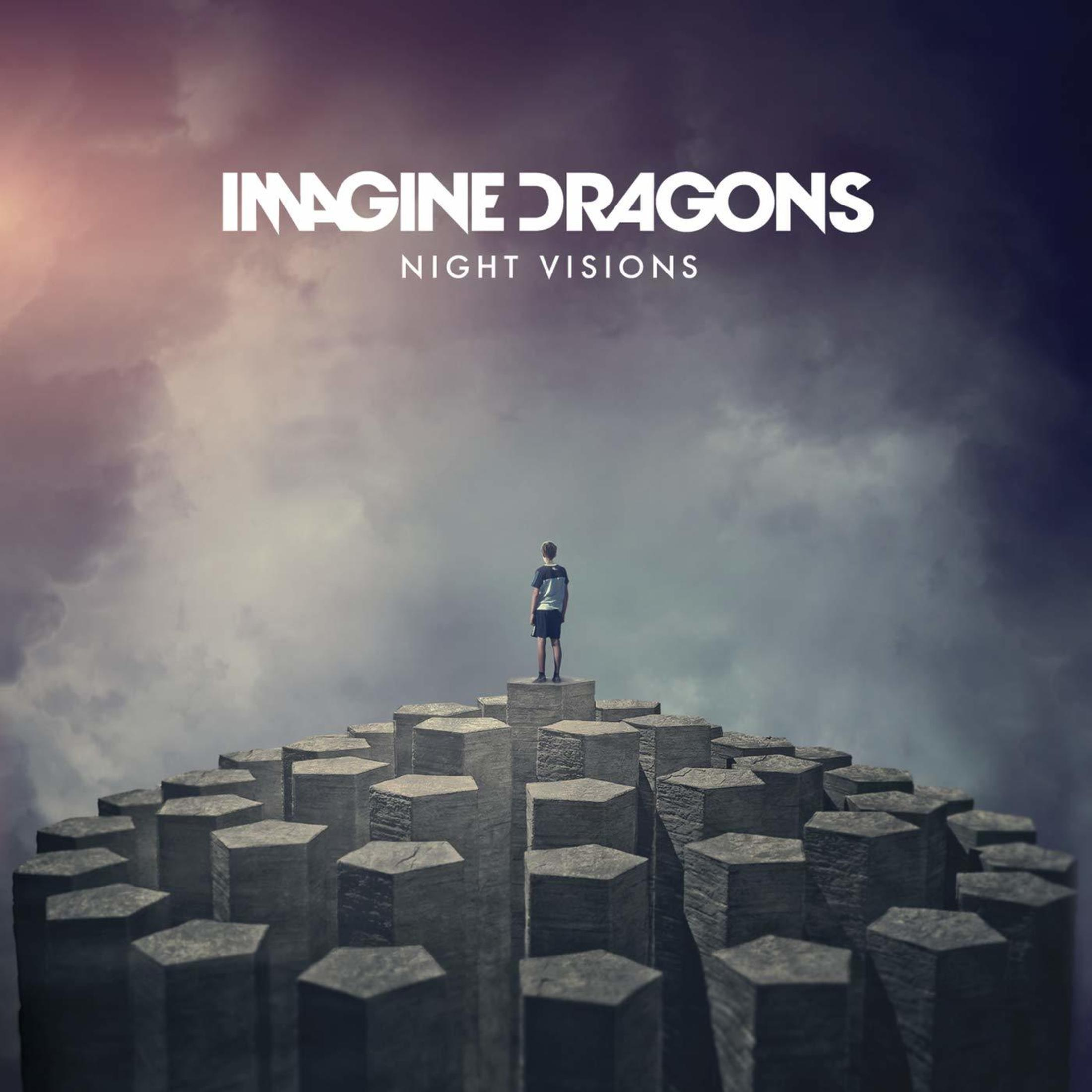 Copertina dell'album Imagine Dragons: Persona in piedi su alte strutture esagonali contro un cielo nuvoloso.