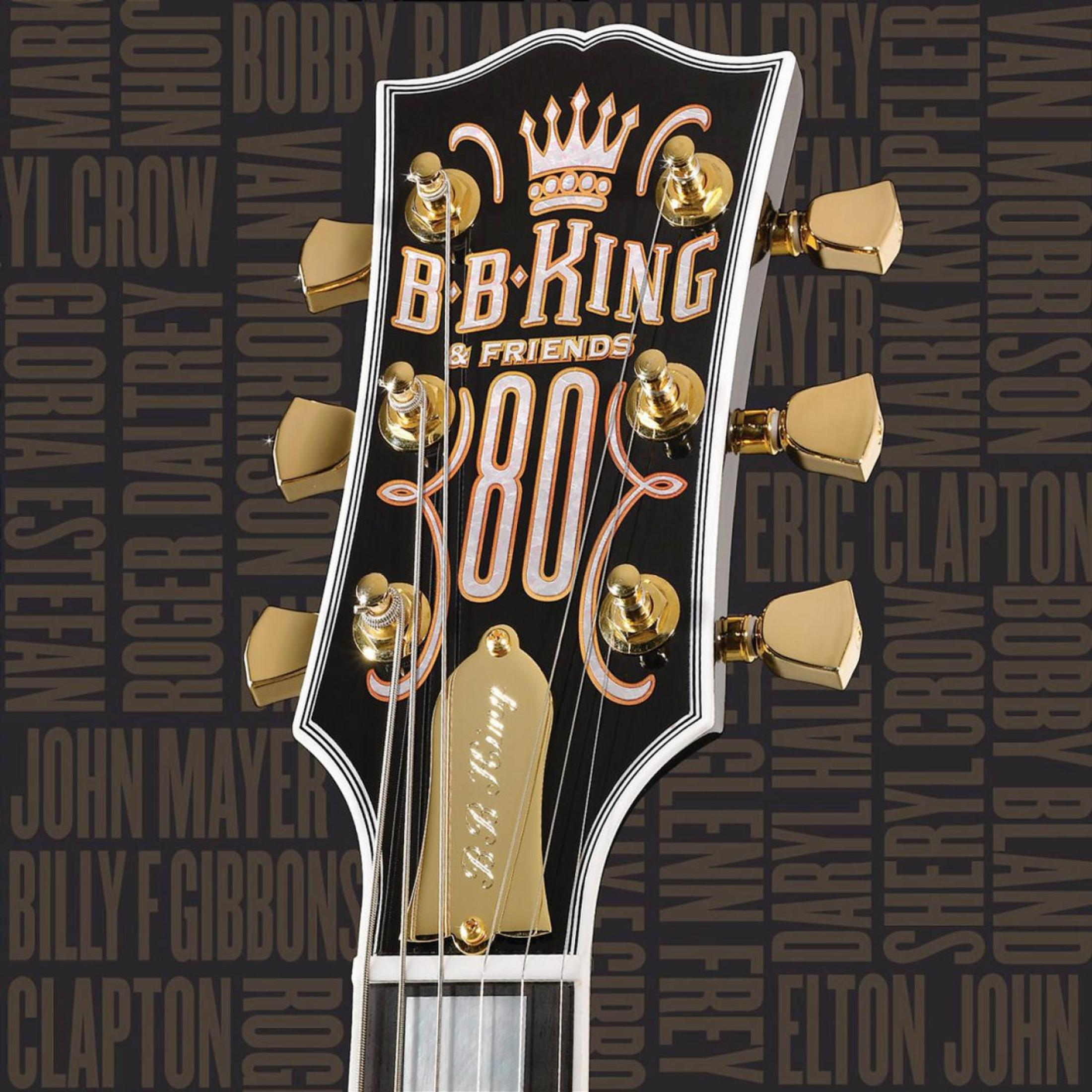 Een gitaarkop met gouden stemschroeven. B.B. King & Friends 80 staat erop geschreven.