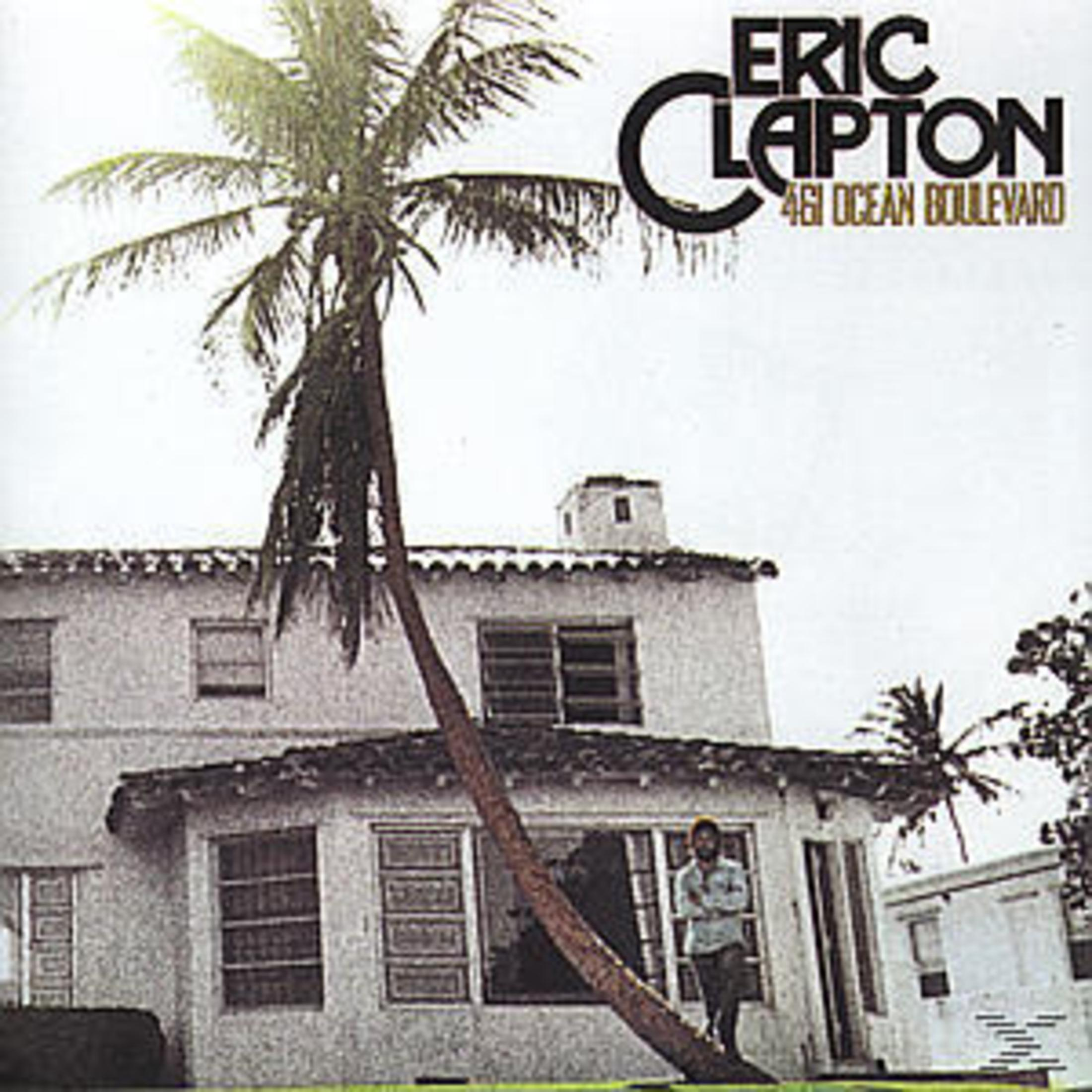Copertina dell'album: Eric Clapton, un uomo in piedi vicino a una casa con una palma.
