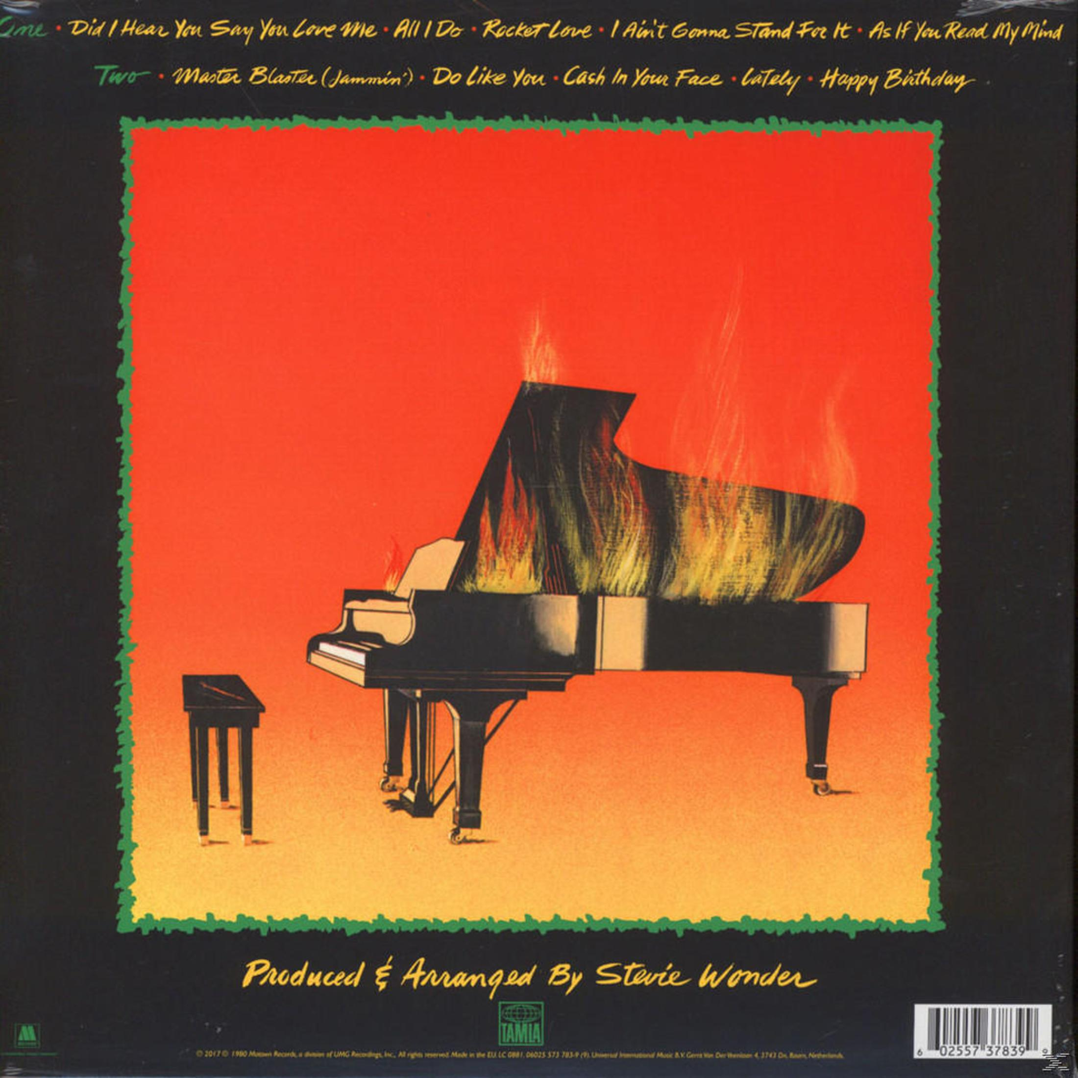 Pianoforte in fiamme su sfondo rosso. Copertina dell'album di Stevie Wonder.