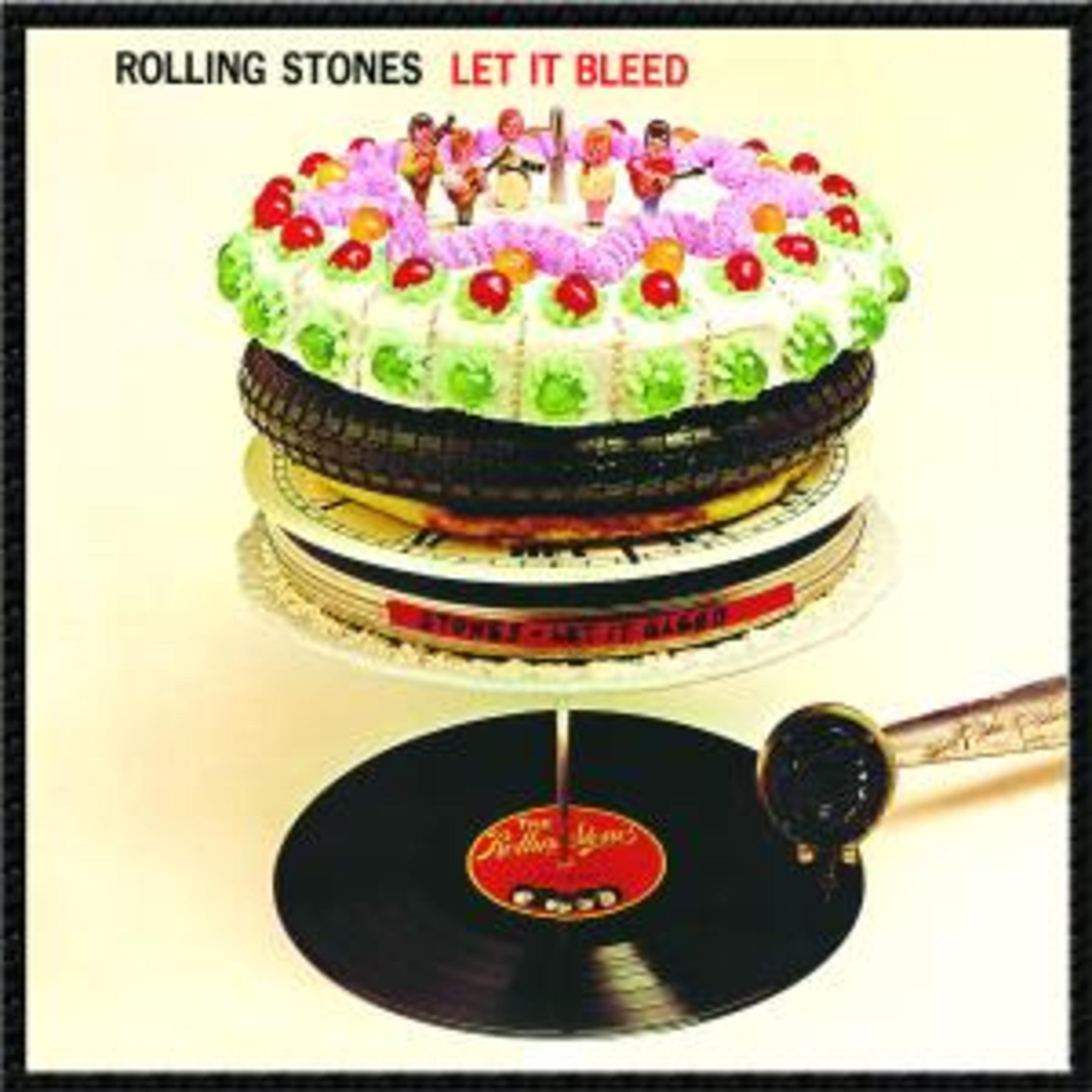 Copertina dell'album 'Let It Bleed' dei Rolling Stones, una torta con figure e pneumatico.