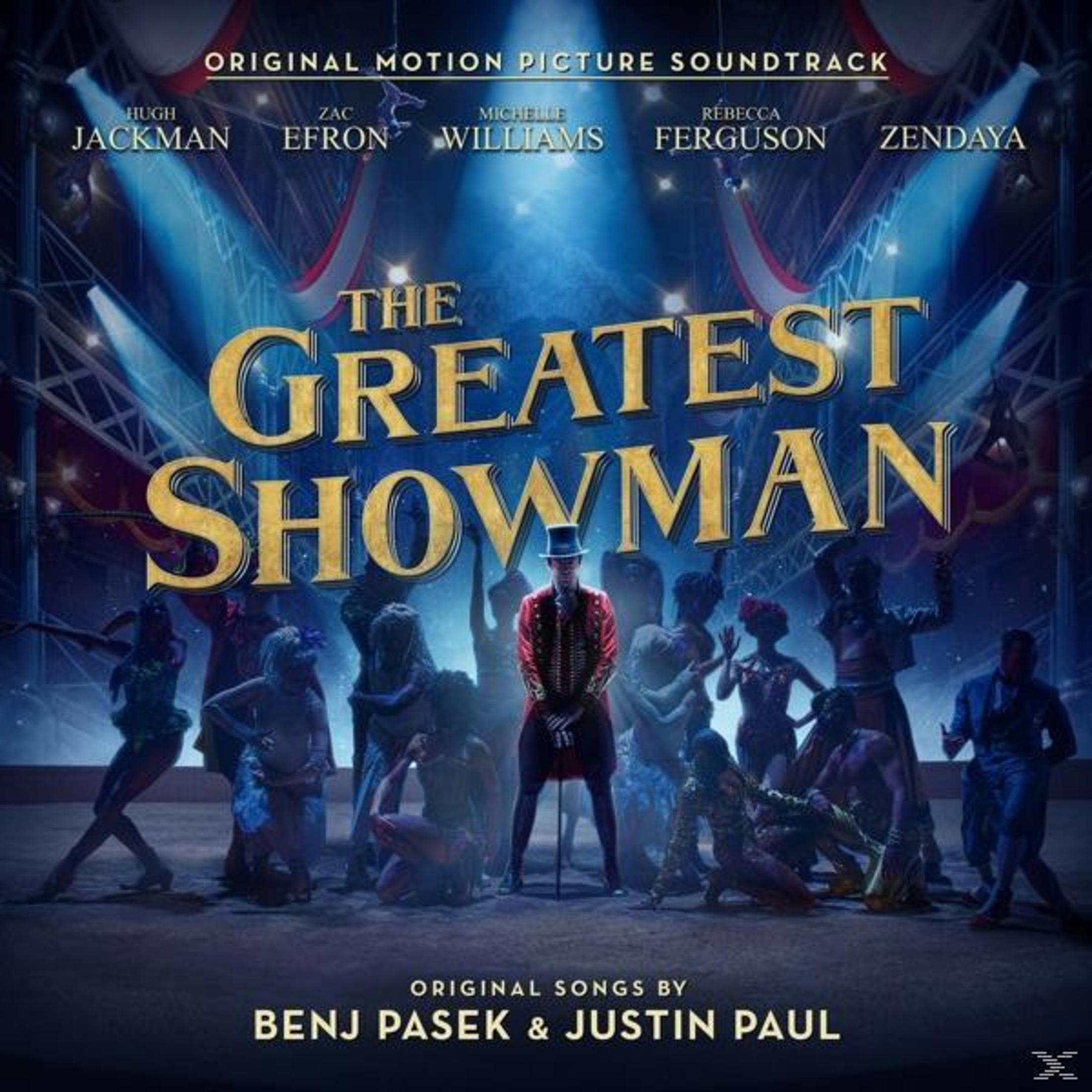 Plakat filmu The Greatest Showman z Hugh Jackmanem, Zakiem Efronem i innymi na tle cyrku.