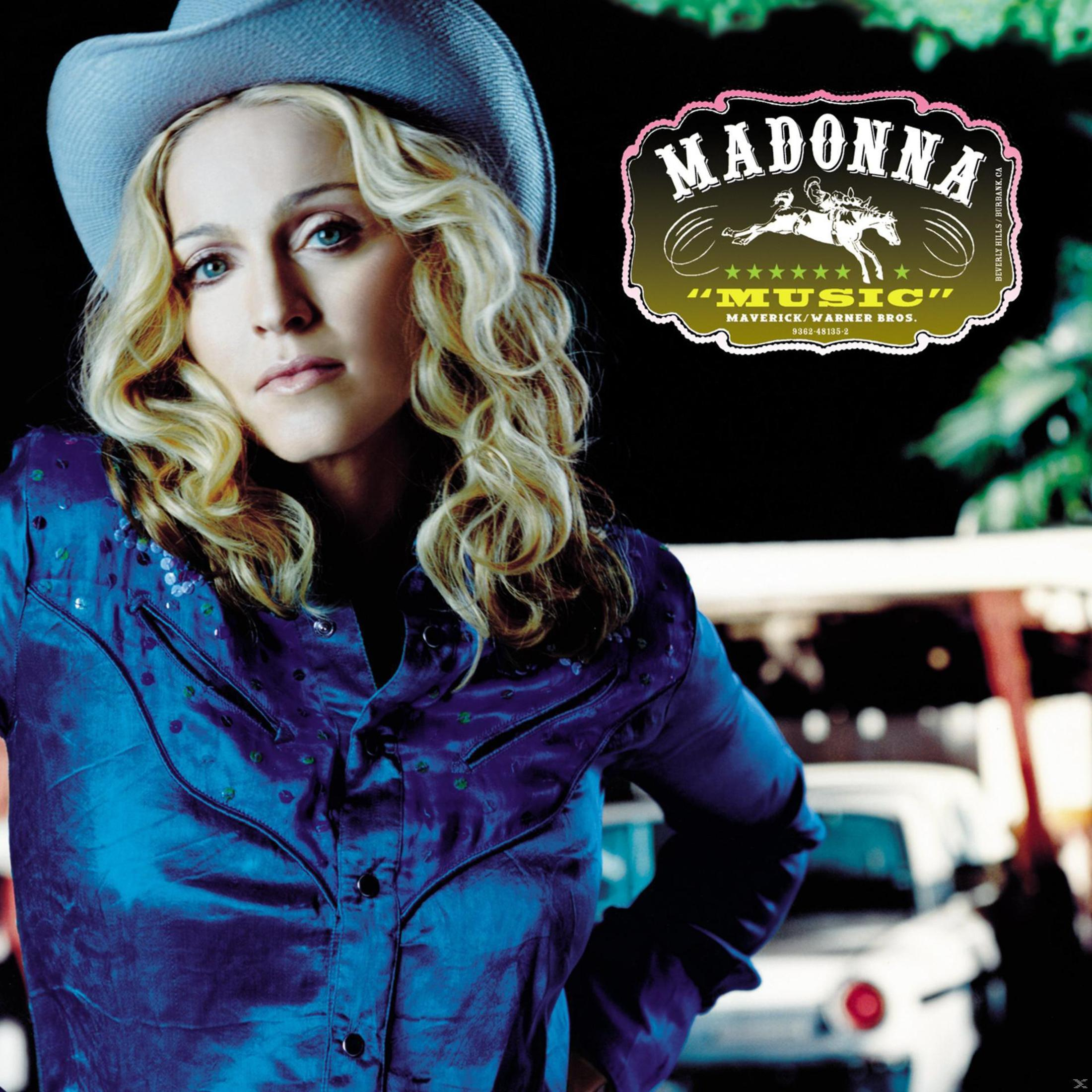 Madonna con una camicia blu e un cappello da cowboy. Titolo dell'album: Music.