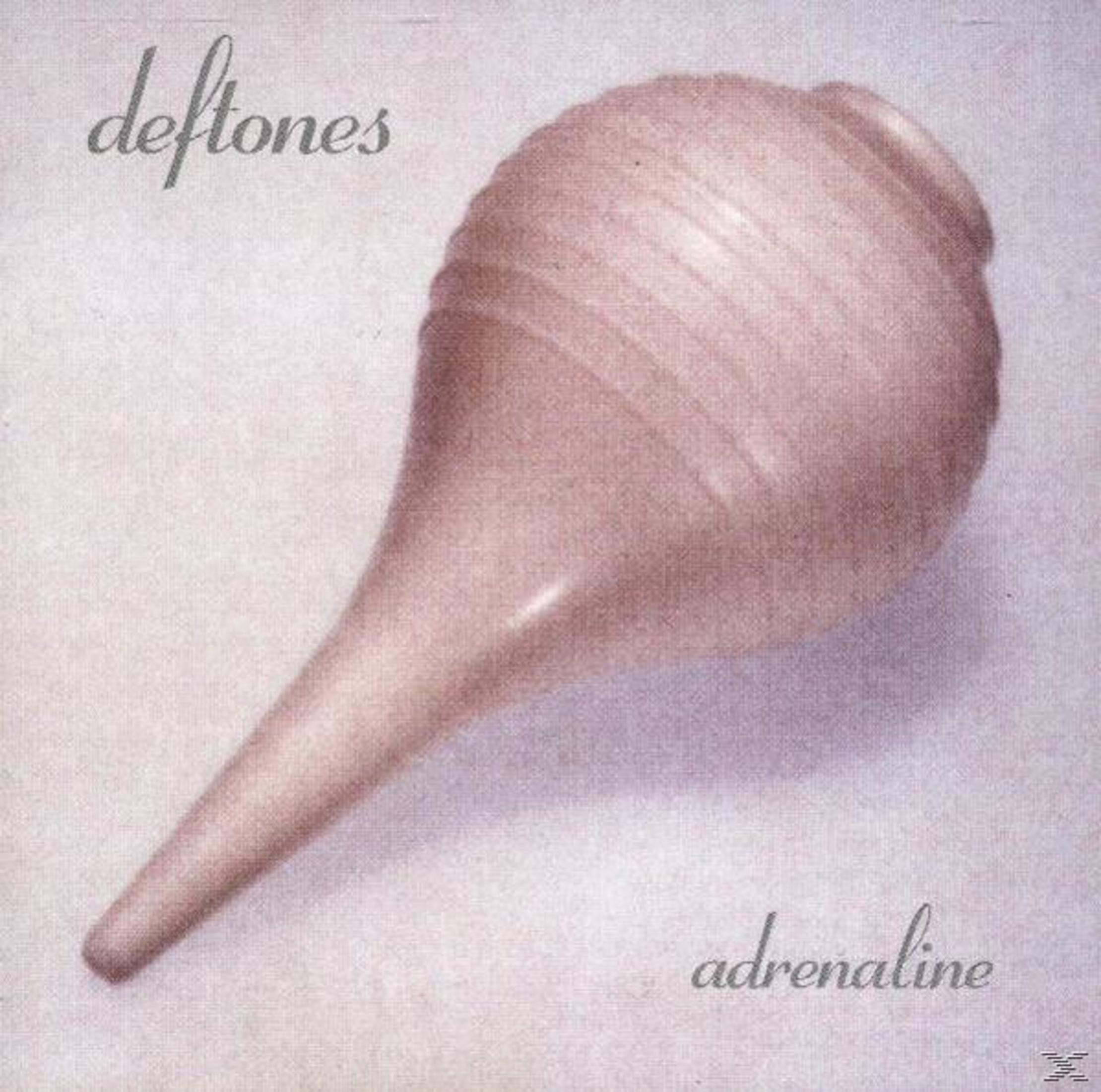 Albumhoes: Deftones, titel 'Adrenaline'. Roze, bolvormig object, lichte achtergrond.