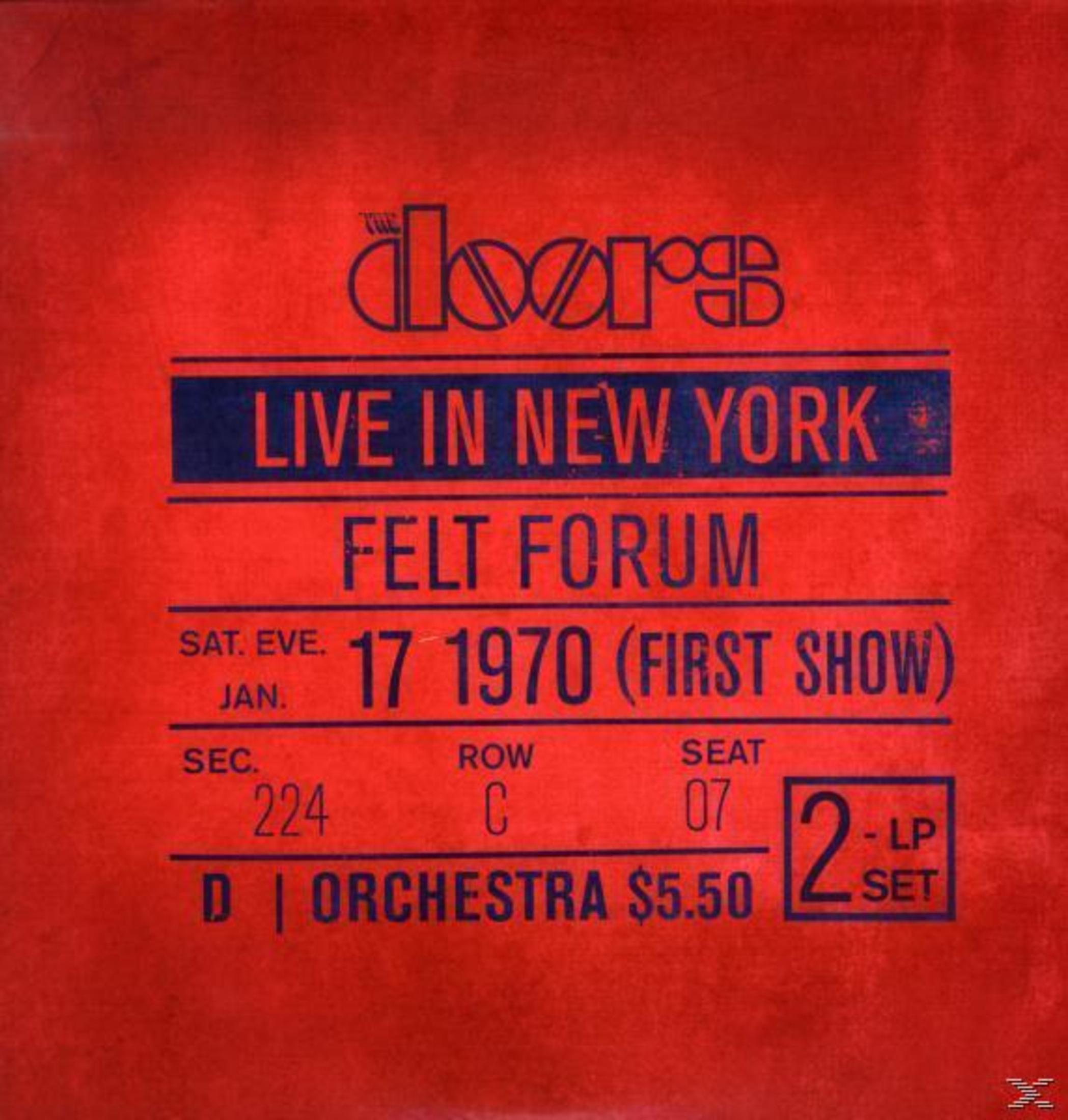 Copertina dell'album. Sfondo rosso con testo blu: 'LIVE IN NEW YORK FELT FORUM' e dettagli del concerto.