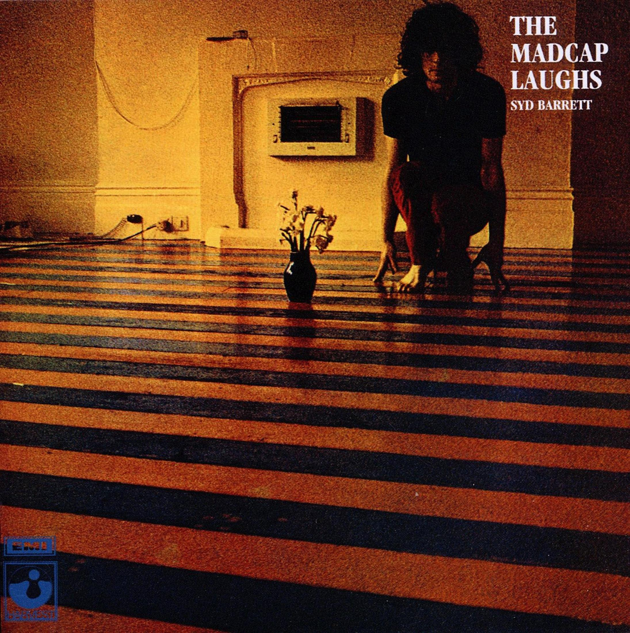 Copertina dell'album con un uomo seduto su una sedia di fronte a un camino, con strisce nere e arancioni sul pavimento.
