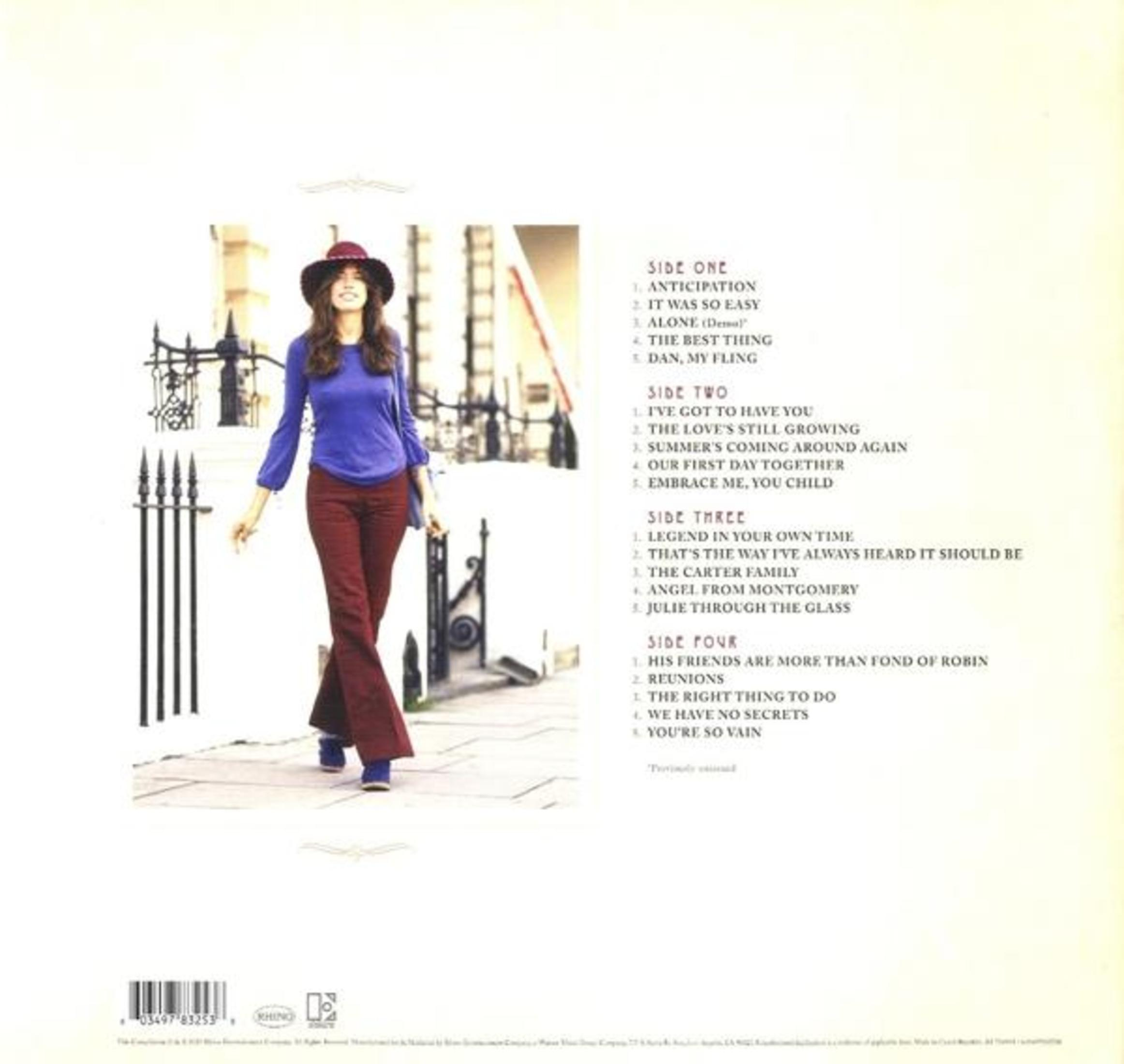 Portada del álbum con una mujer caminando por una calle, detalles del álbum y listas de canciones.