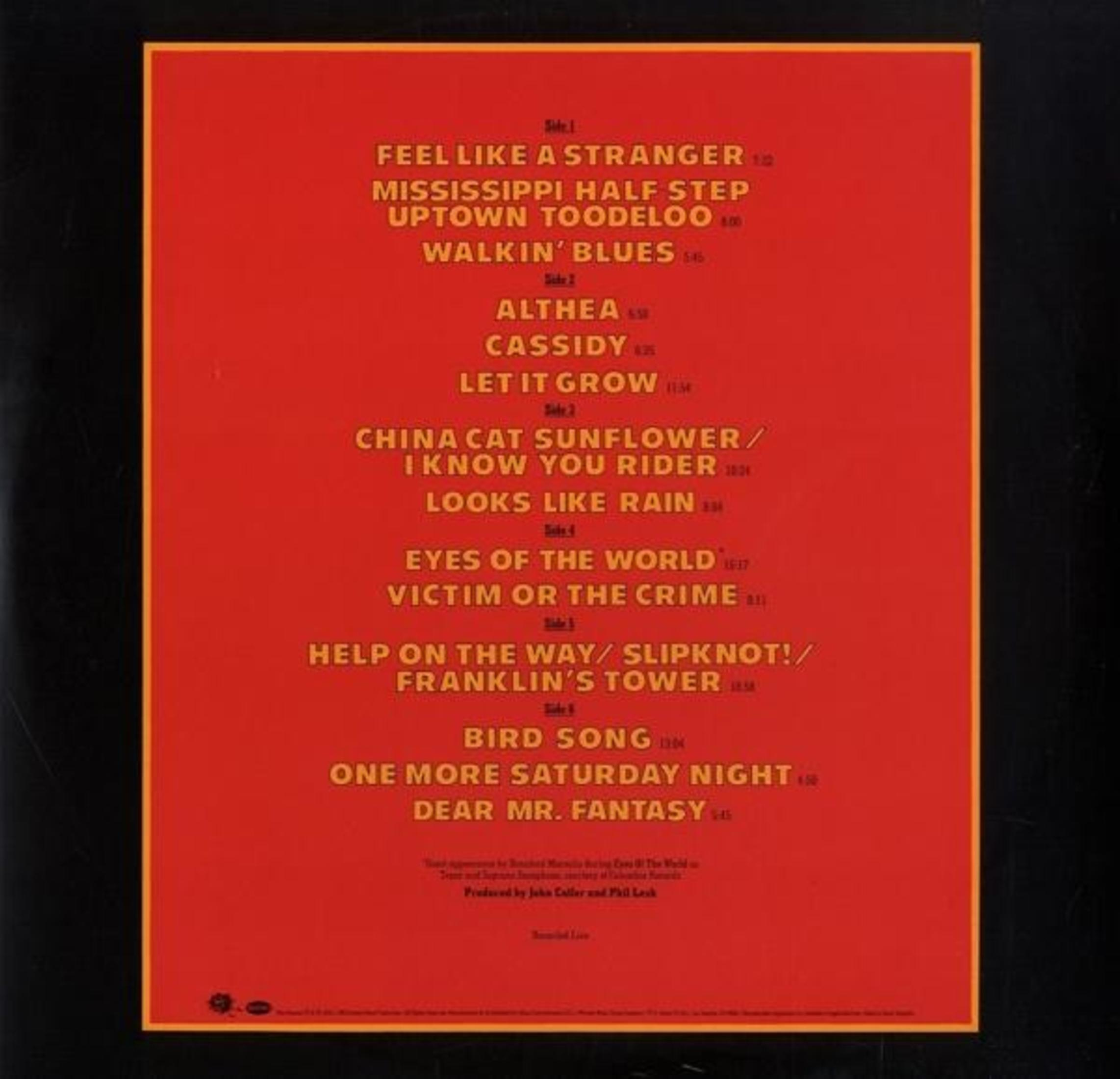 Contraportada del álbum con lista de canciones, créditos y un fondo amarillo y marrón.