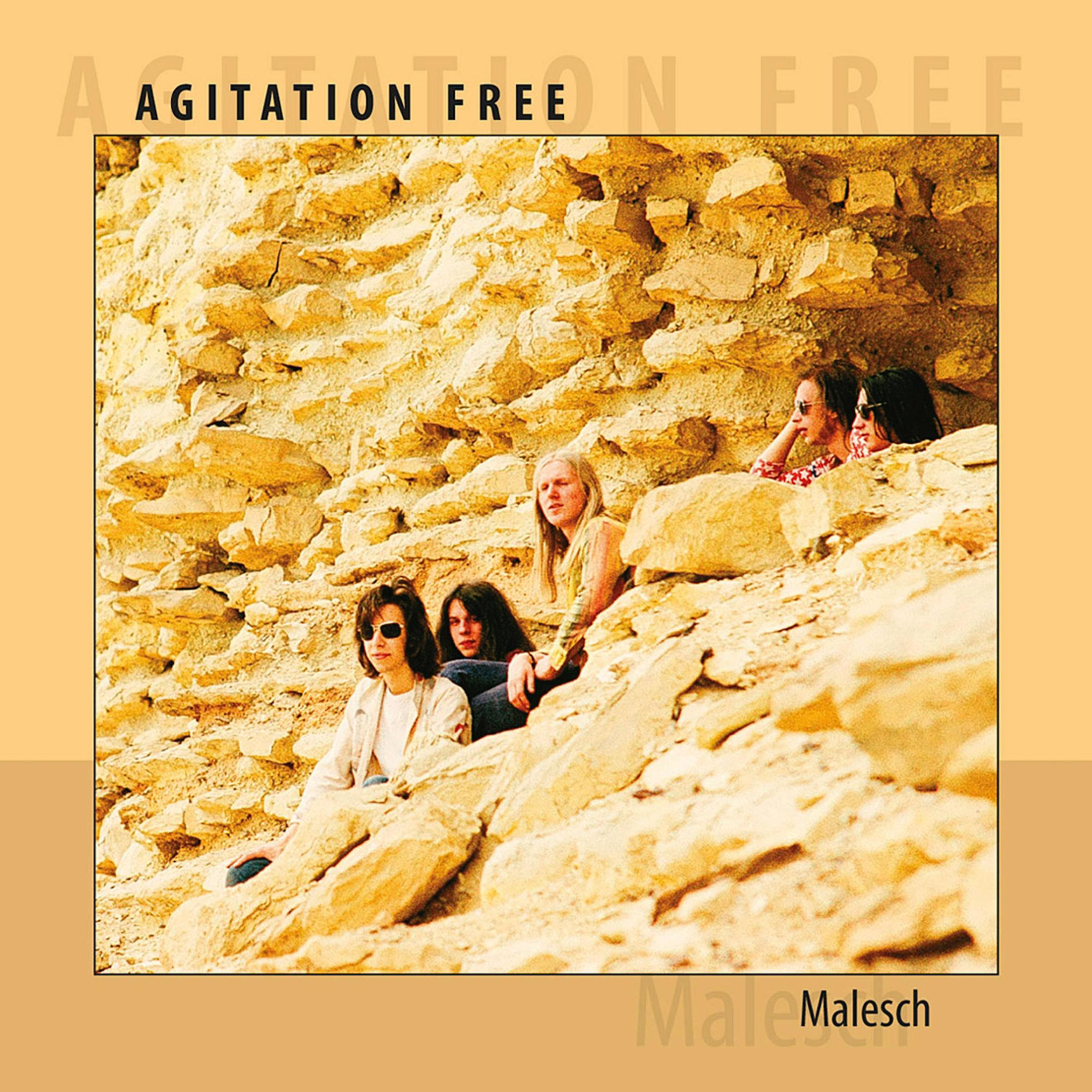 De albumhoes van Agitation Free. De band zit op een rotsformatie.