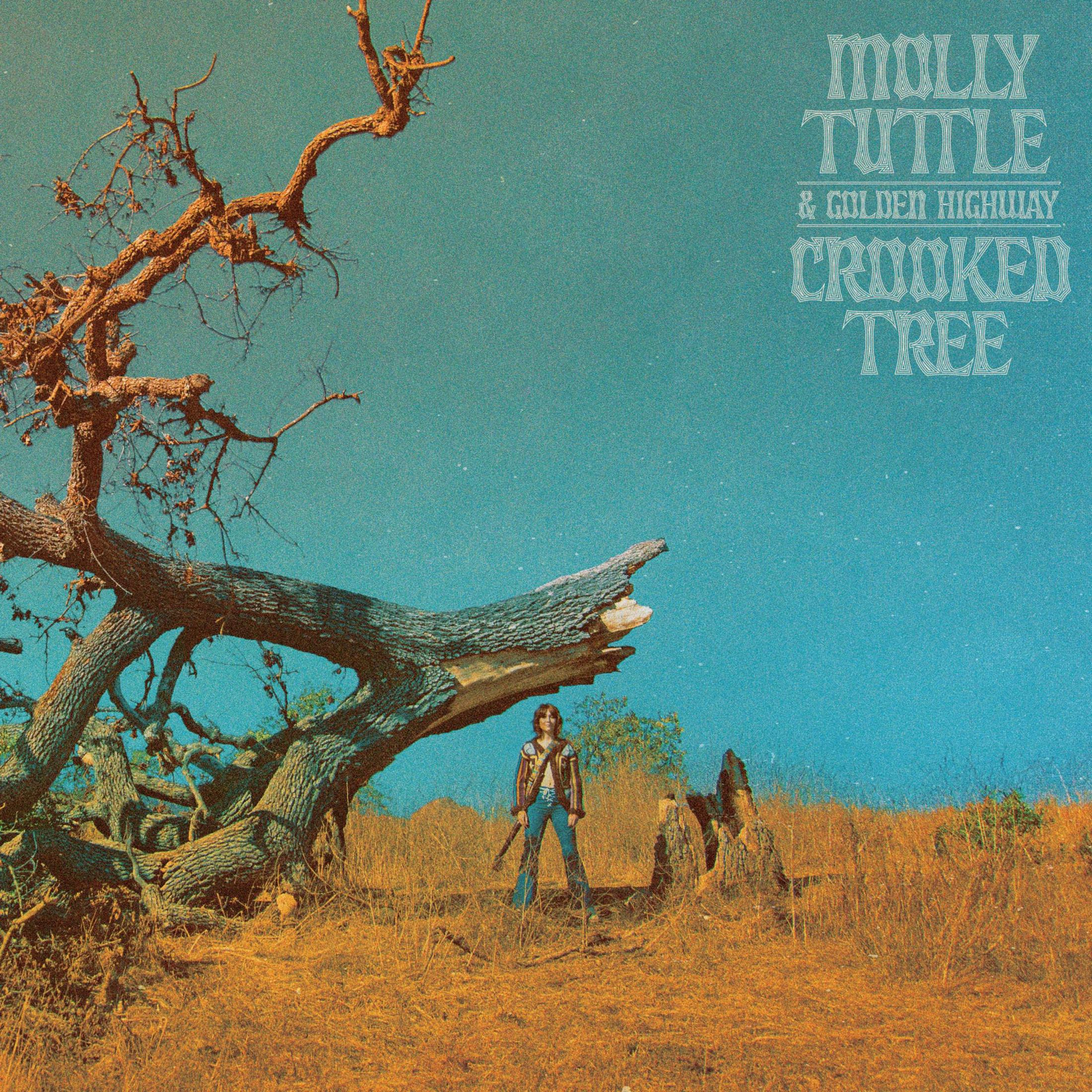 Copertina dell'album con una persona in piedi vicino a un albero storto.